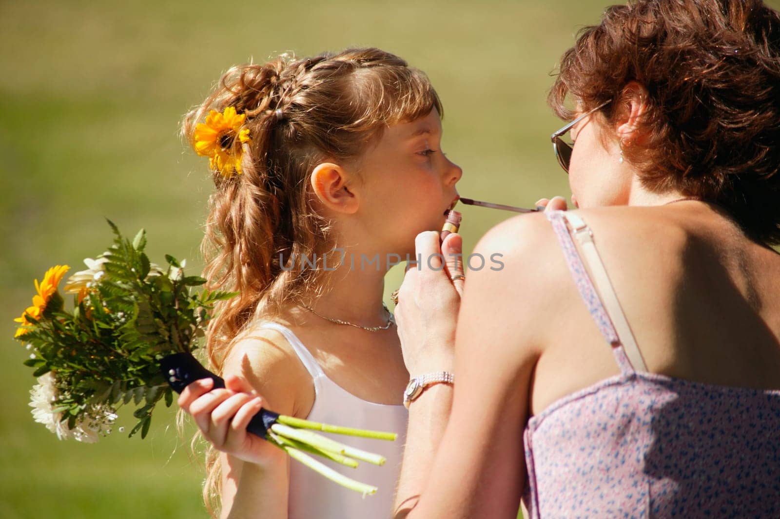 Flower girl getting lipstick