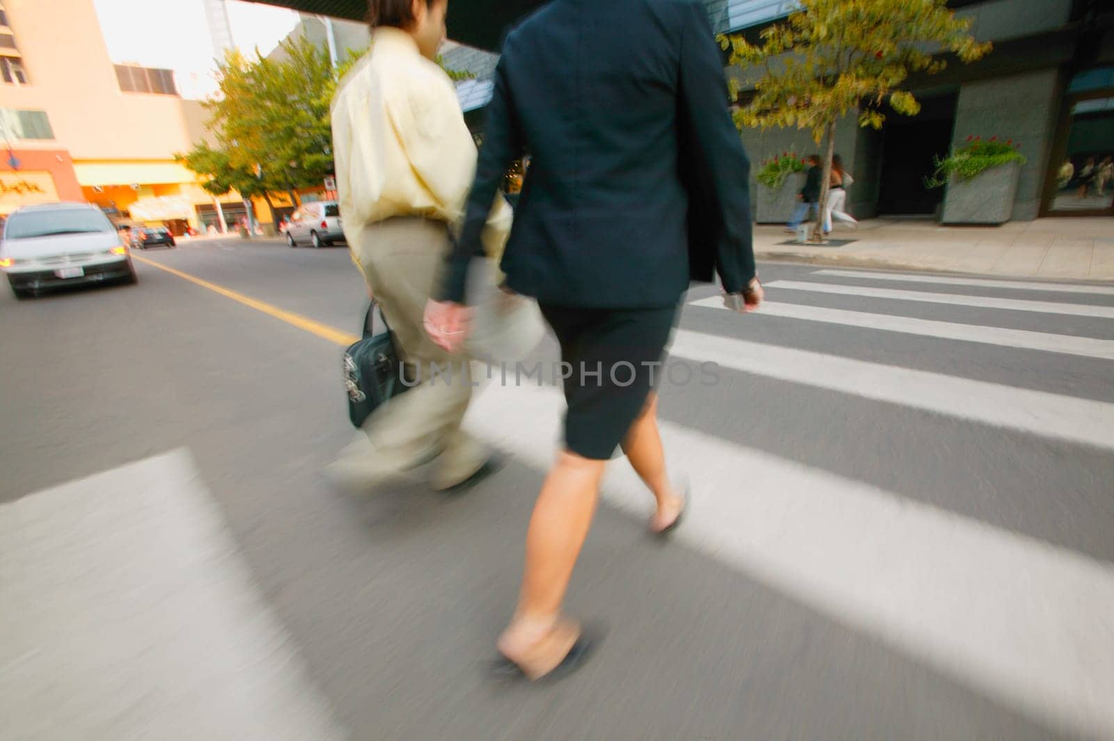 Businesspeople cross the street