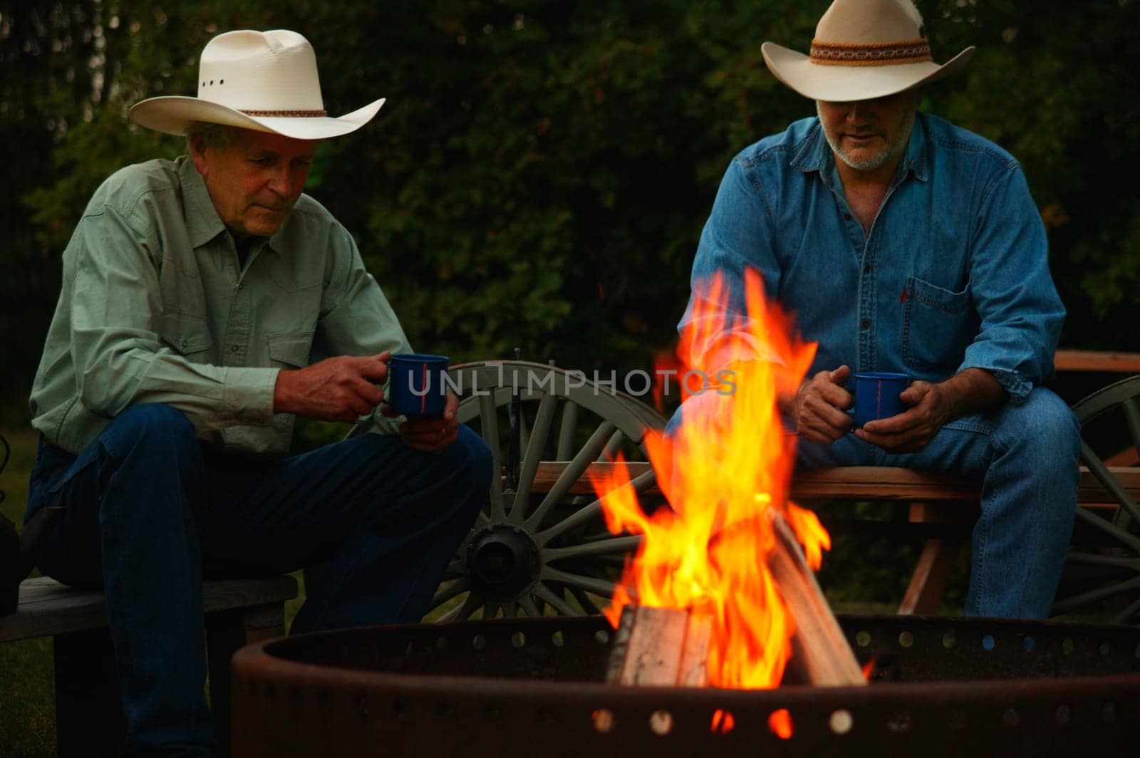 Two men sitting by a fire