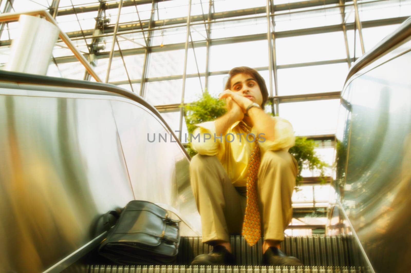 Man sits on an escalator