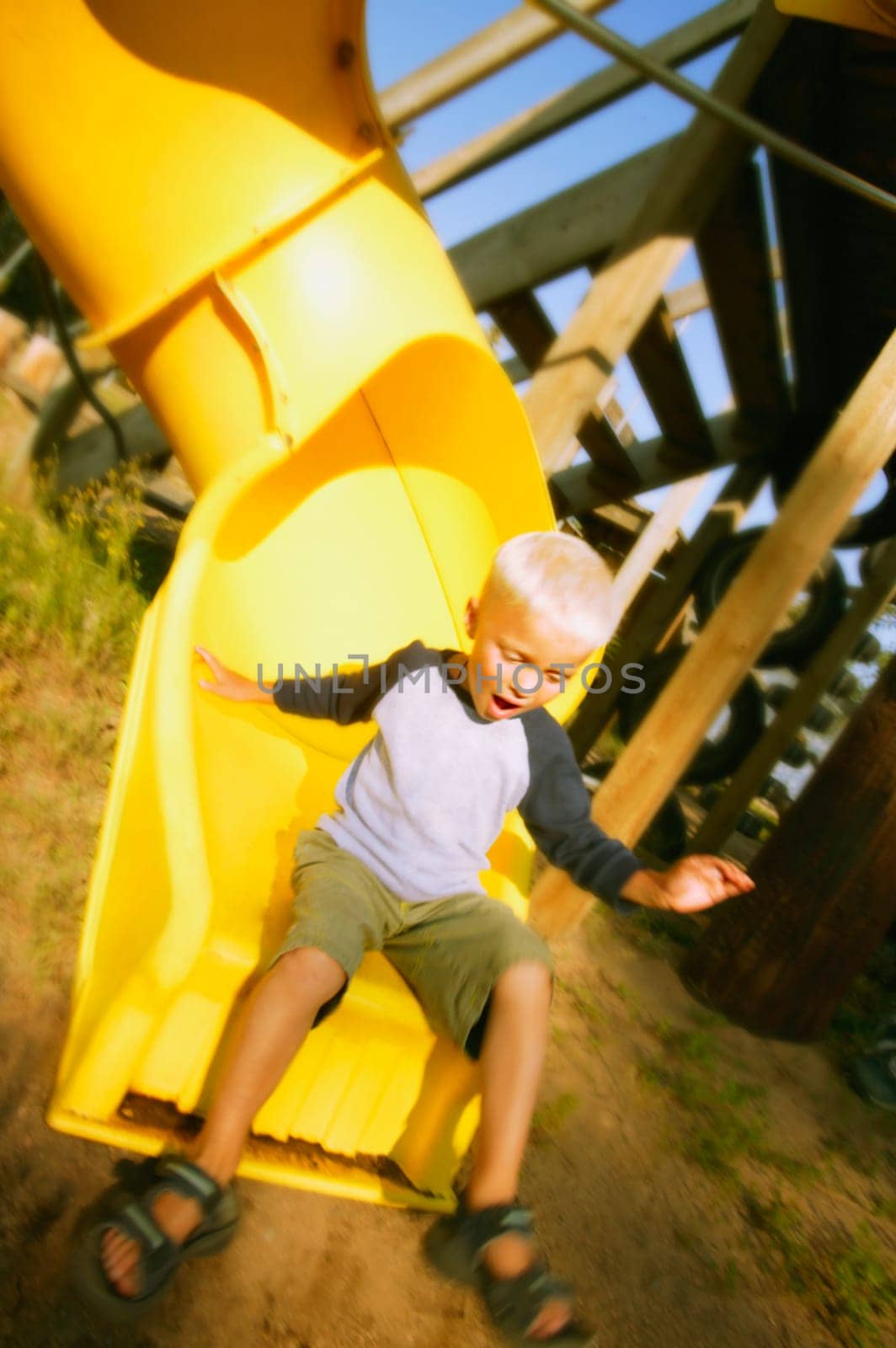 Boy goes down a slide