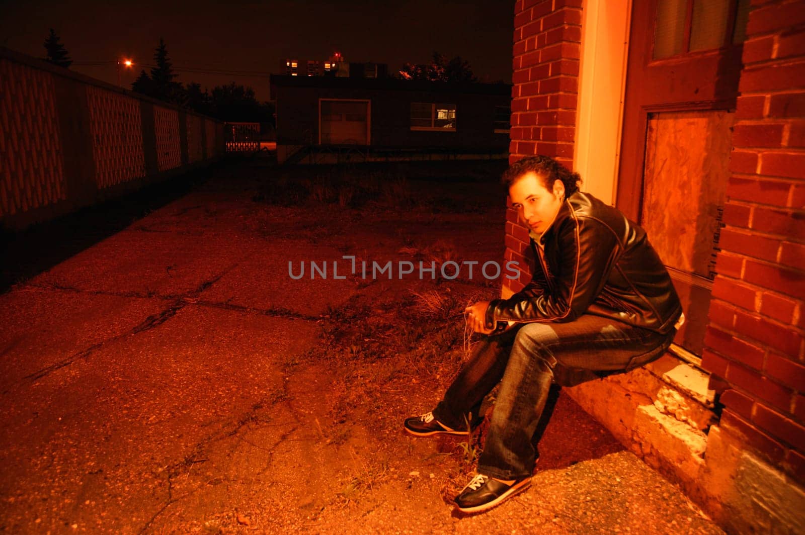 Man sits under street light