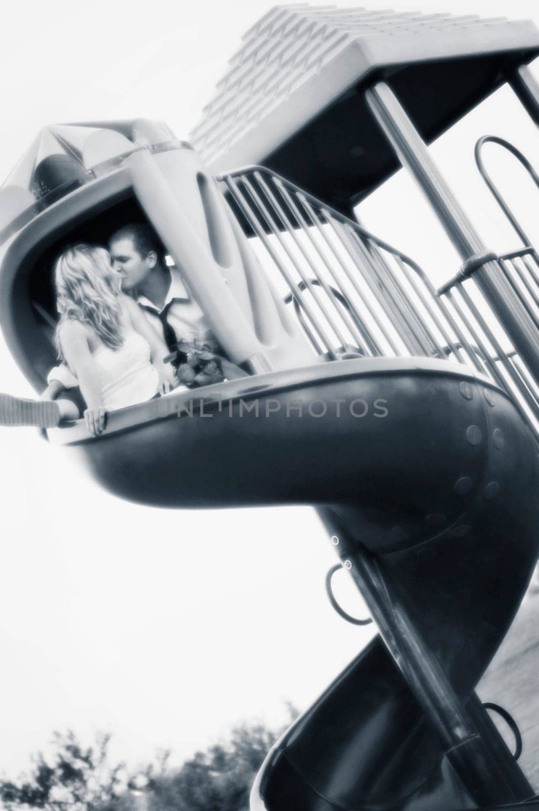 Couple kiss on a slide