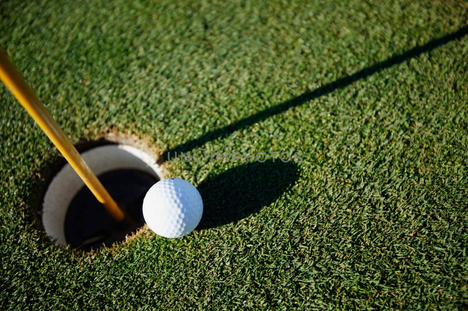 Golf ball close to pin