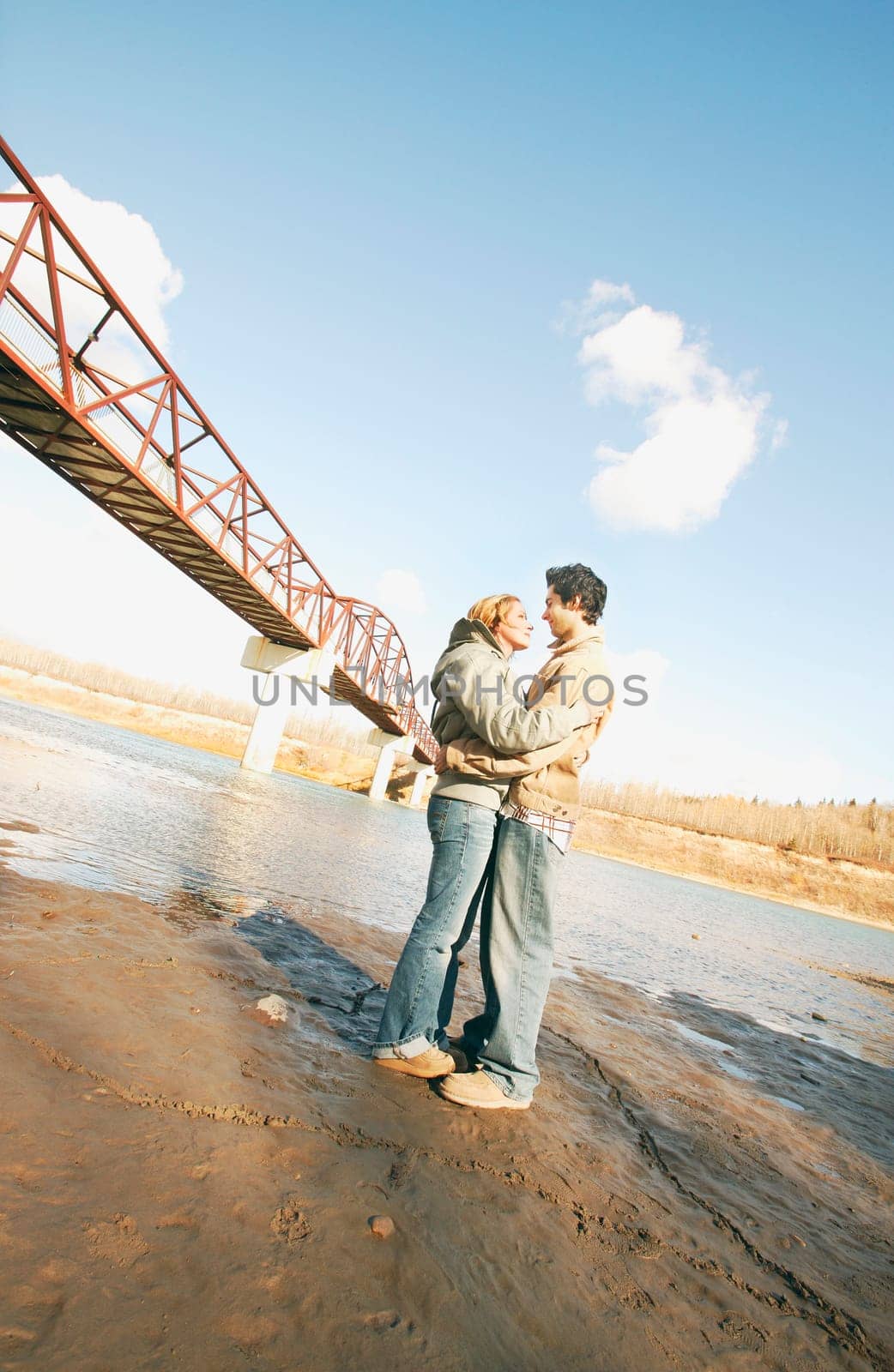 Couple embrace in river valley