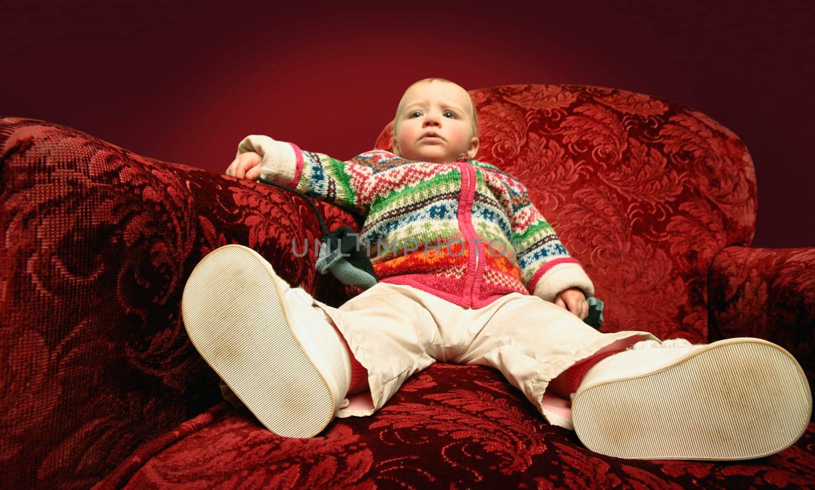 A child sits on a sofa