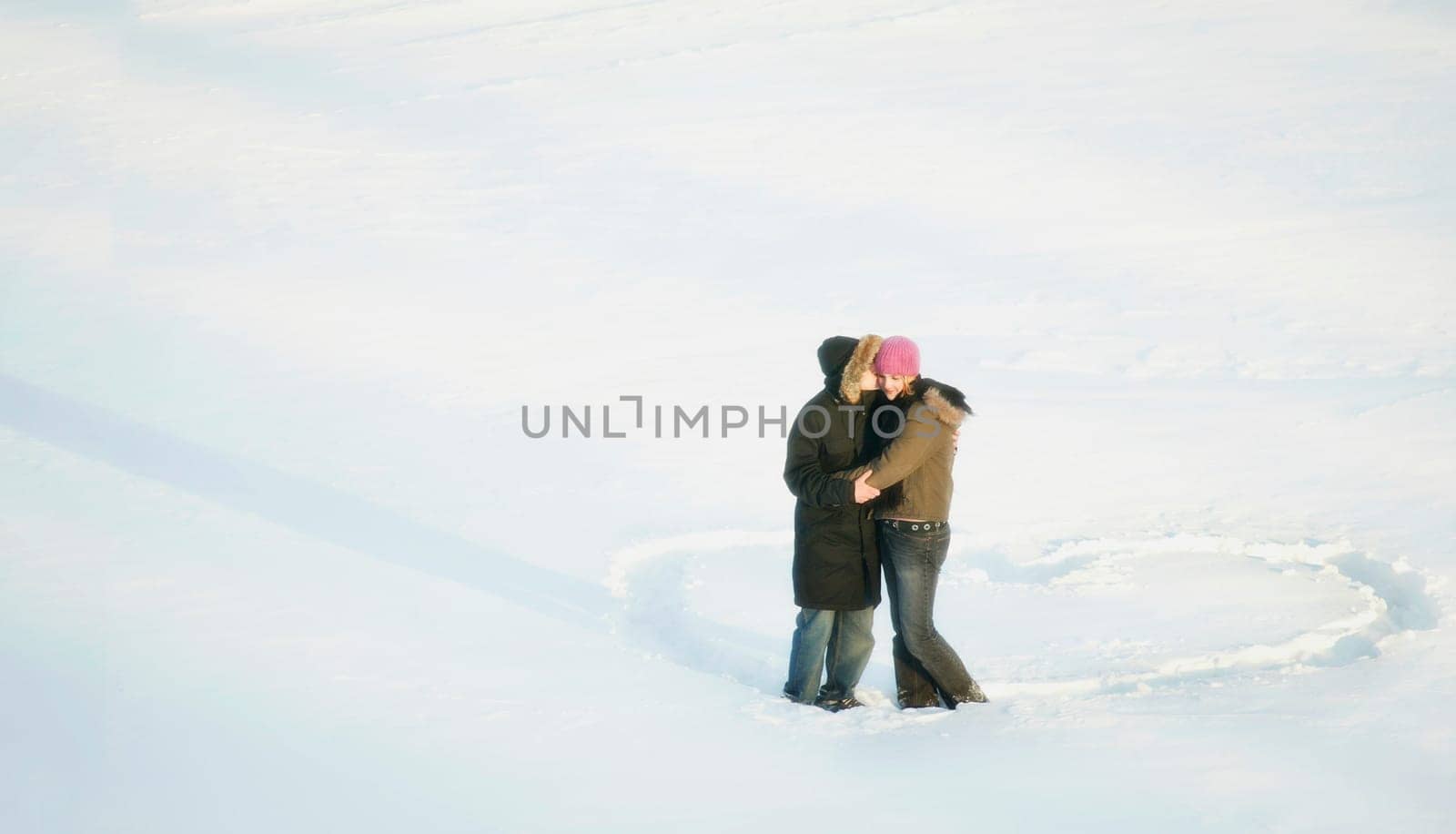 Couple kiss while standing in a heart