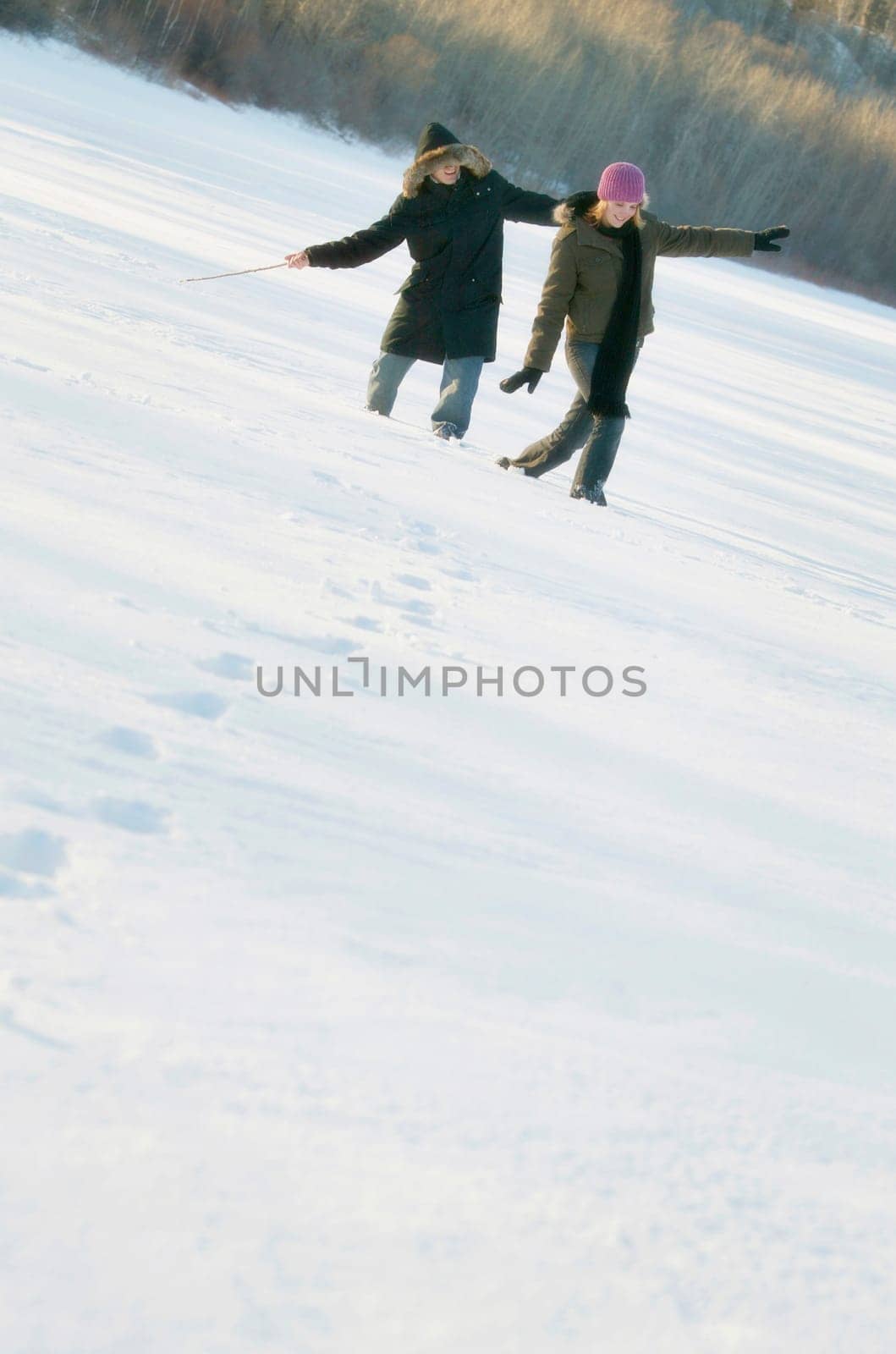 Couple play in the snow