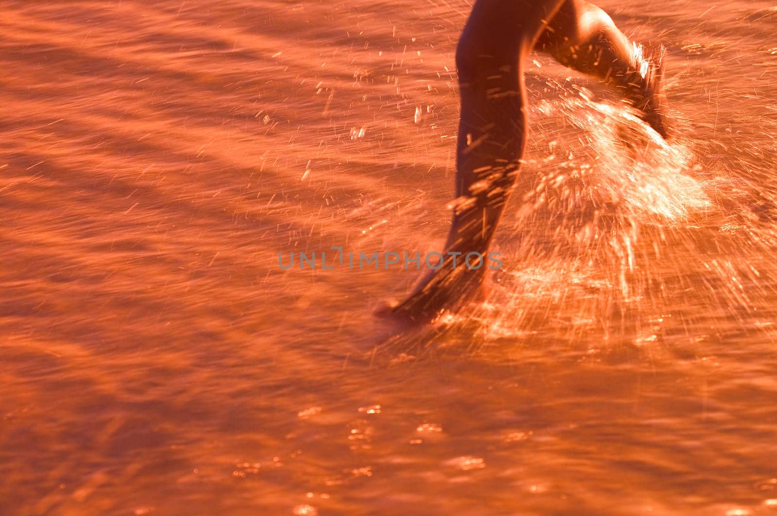 Child Running through water on beach
