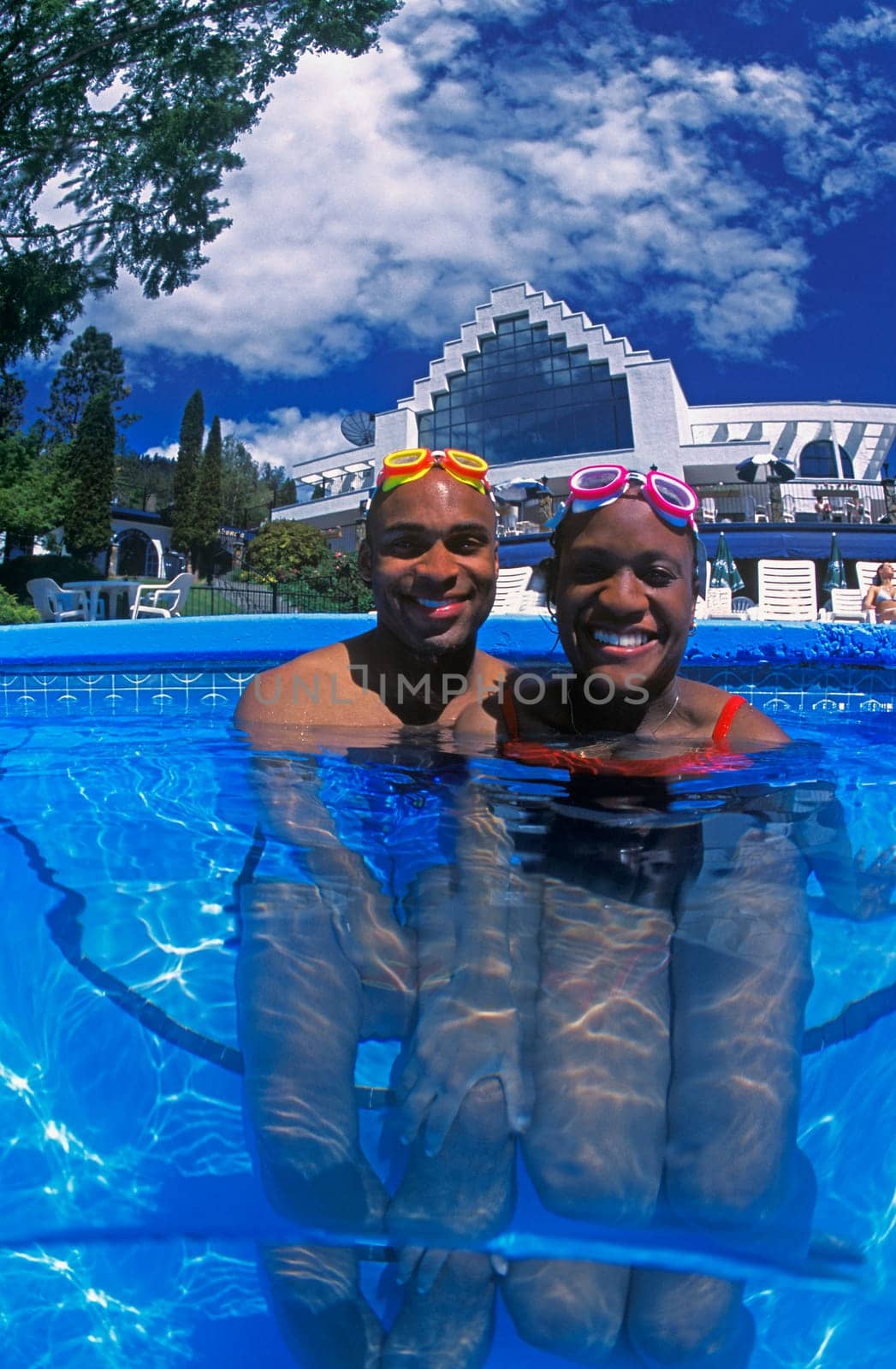 Happy couple having fun in swimming pool