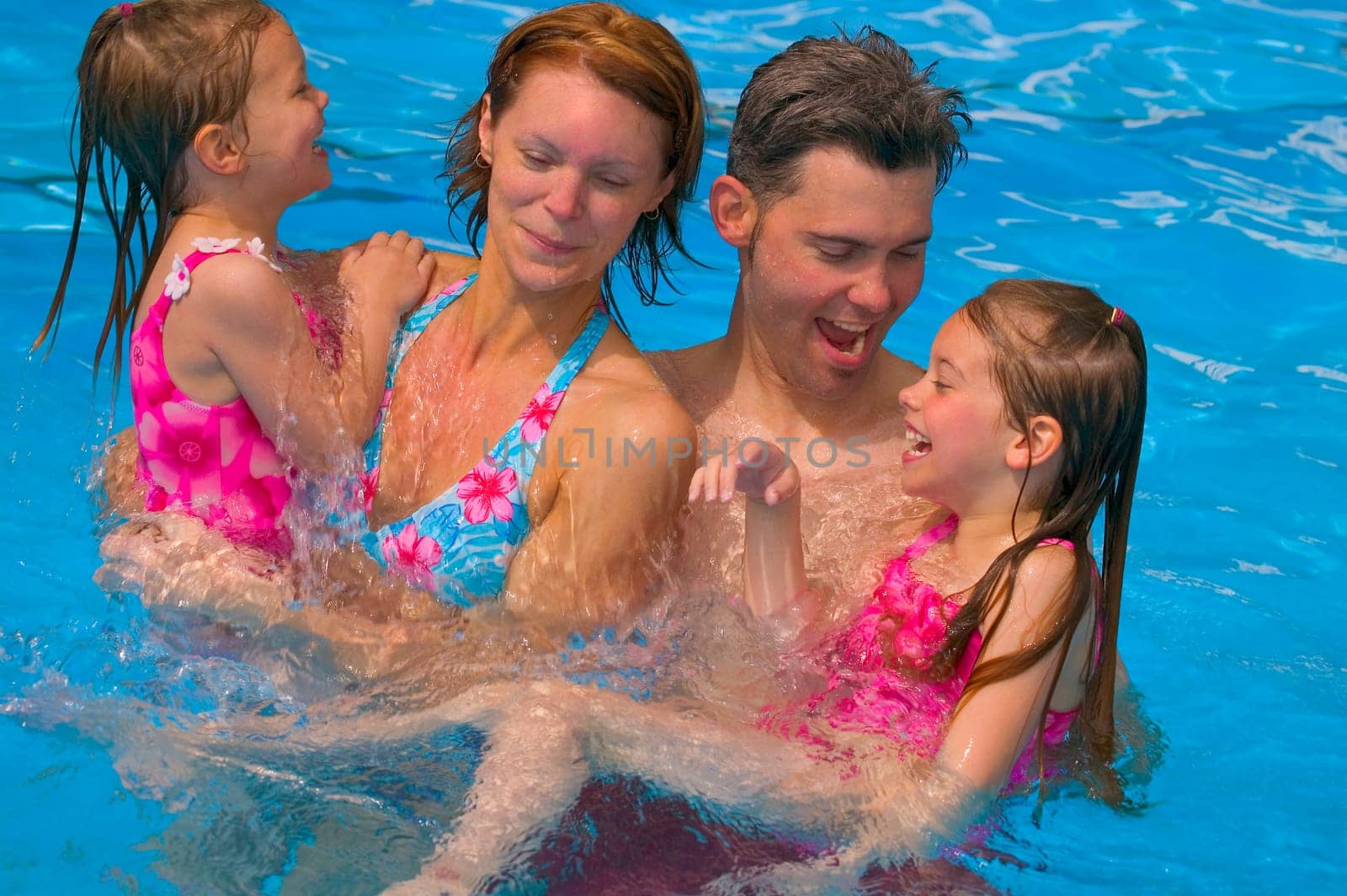 Family having fun in swimming pool