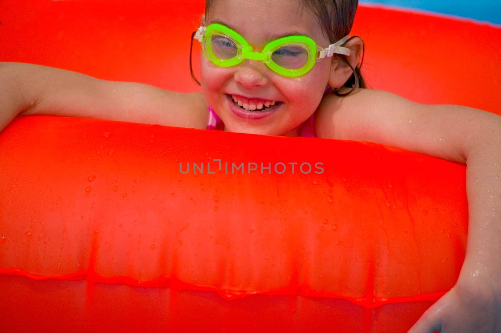 Portrait of little girl playing in Swimming Pool