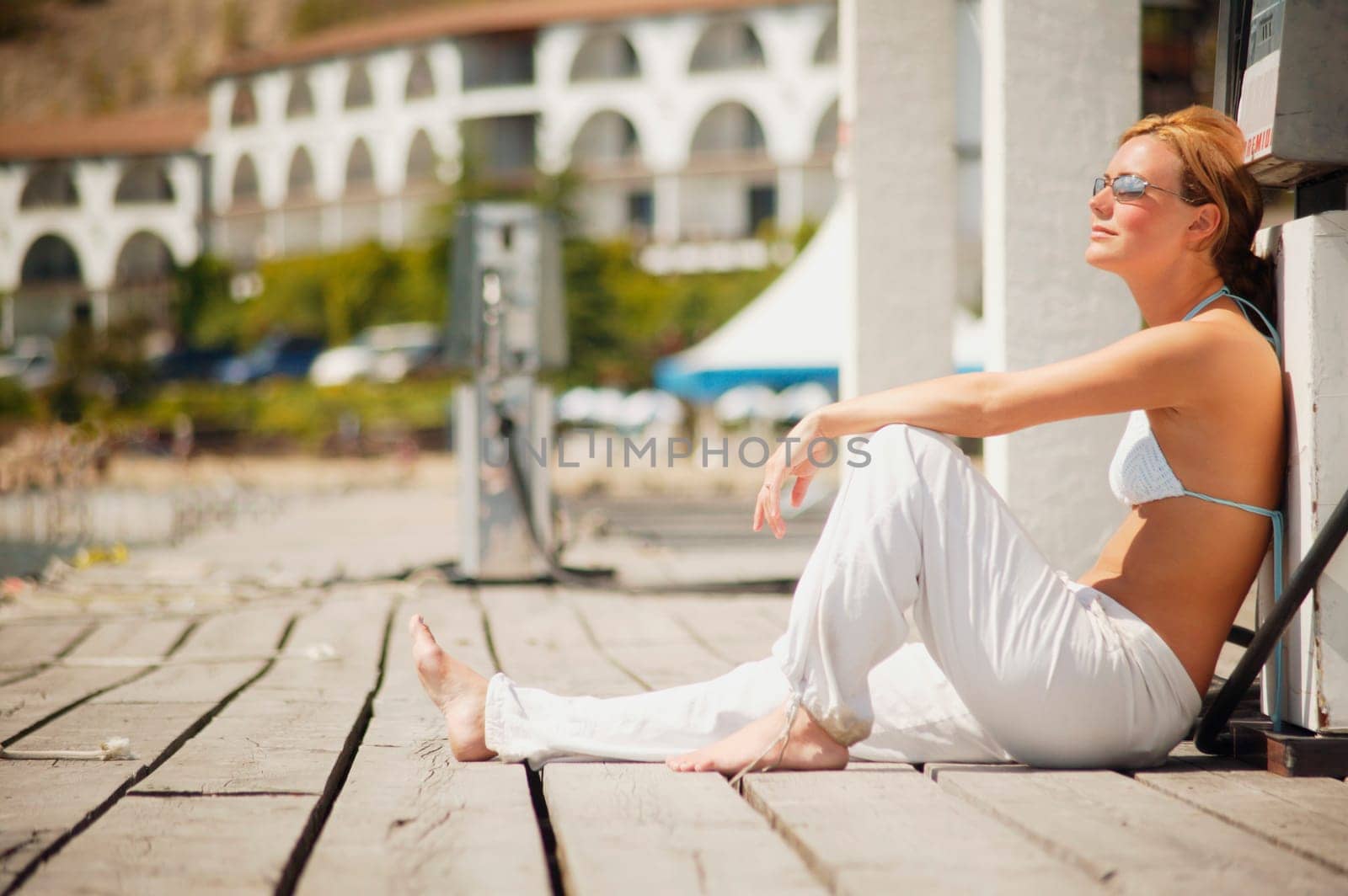 Woman sits on a dock