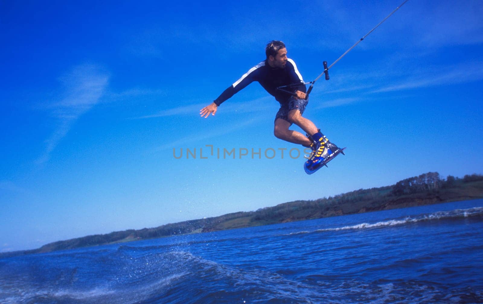 Man wakeboarding on coal Lake Alberta Canada