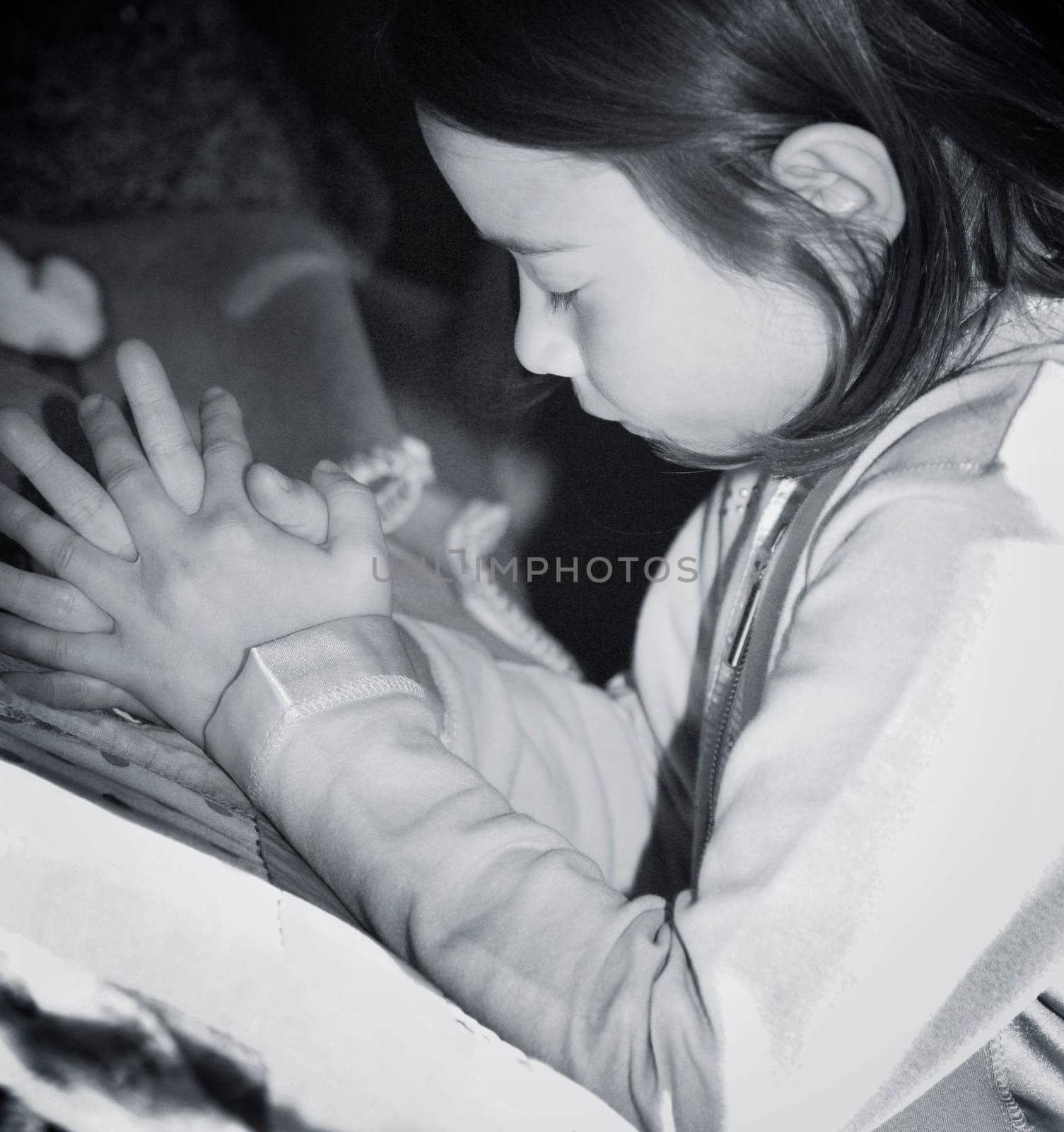 Girl kneeling and praying by bed