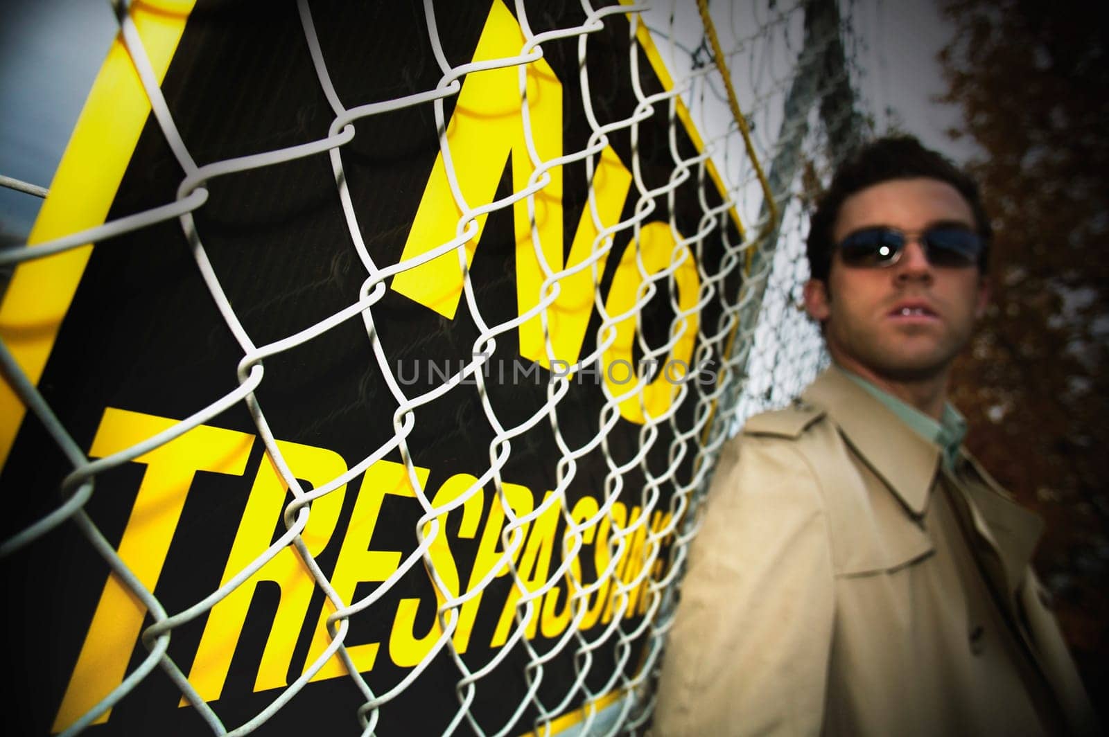 A man beside a no trespassing sign