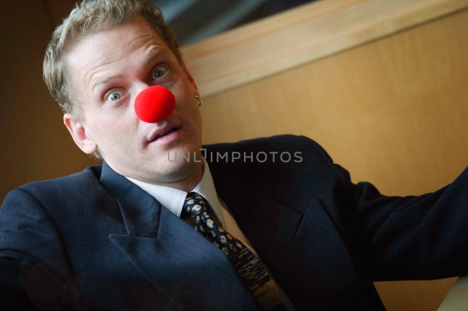Businessman wearing red nose