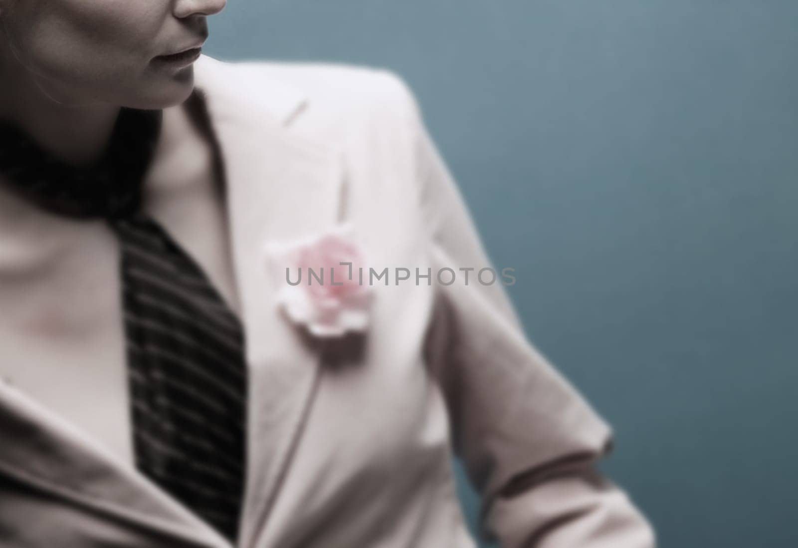 Woman wearing a suit with a pink flower
