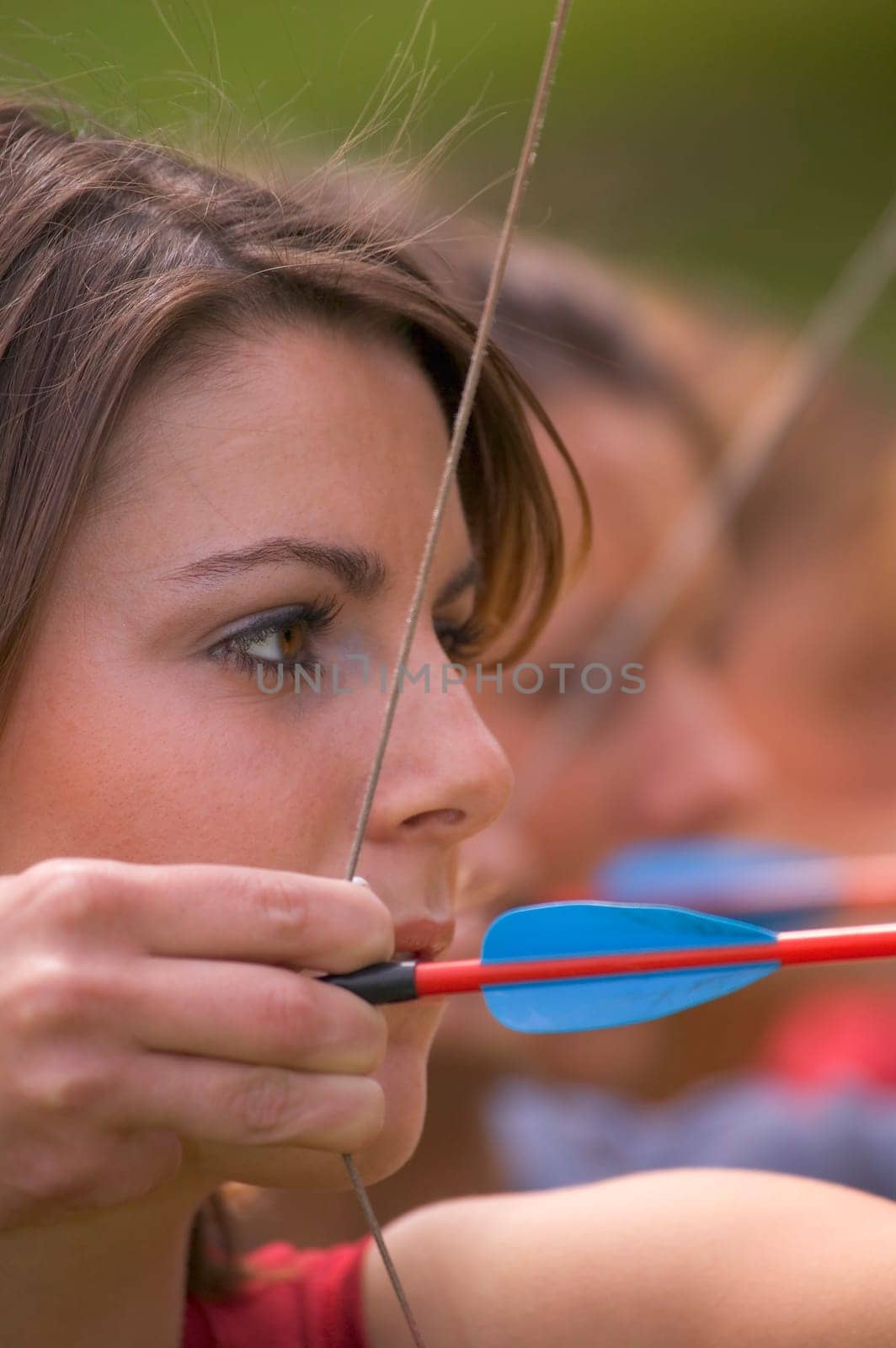 Line of women with bow and arrows