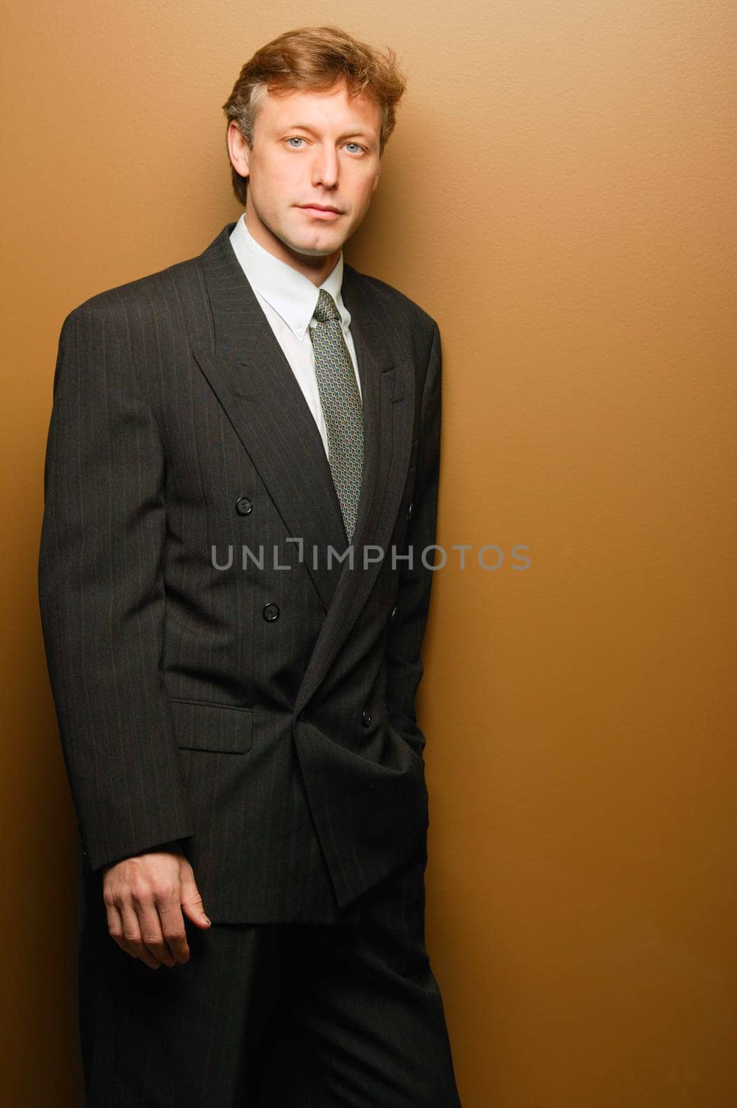 Businessman leaning on wall