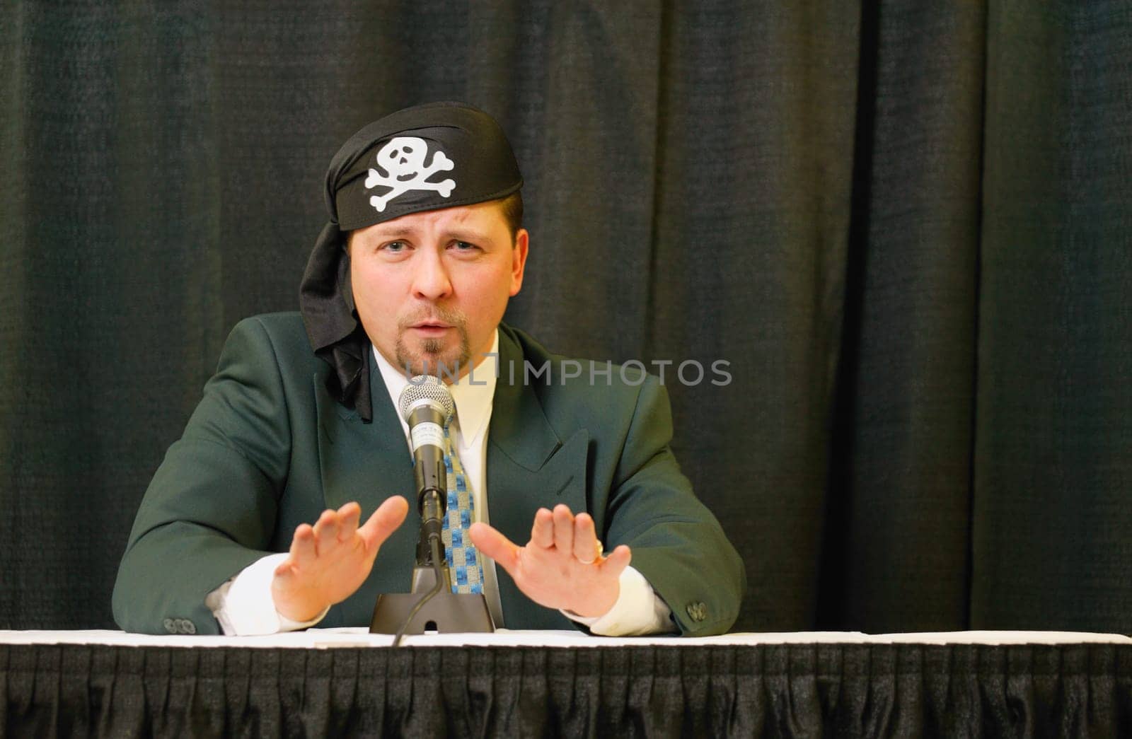 Speaker wearing pirate headgear