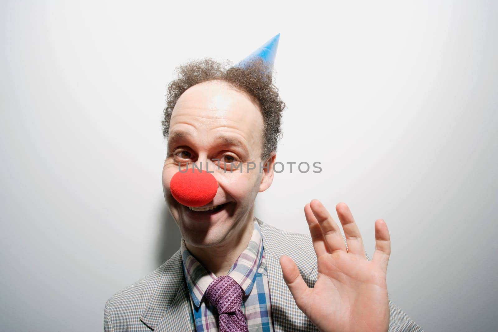 Man wearing a clown's nose and hat