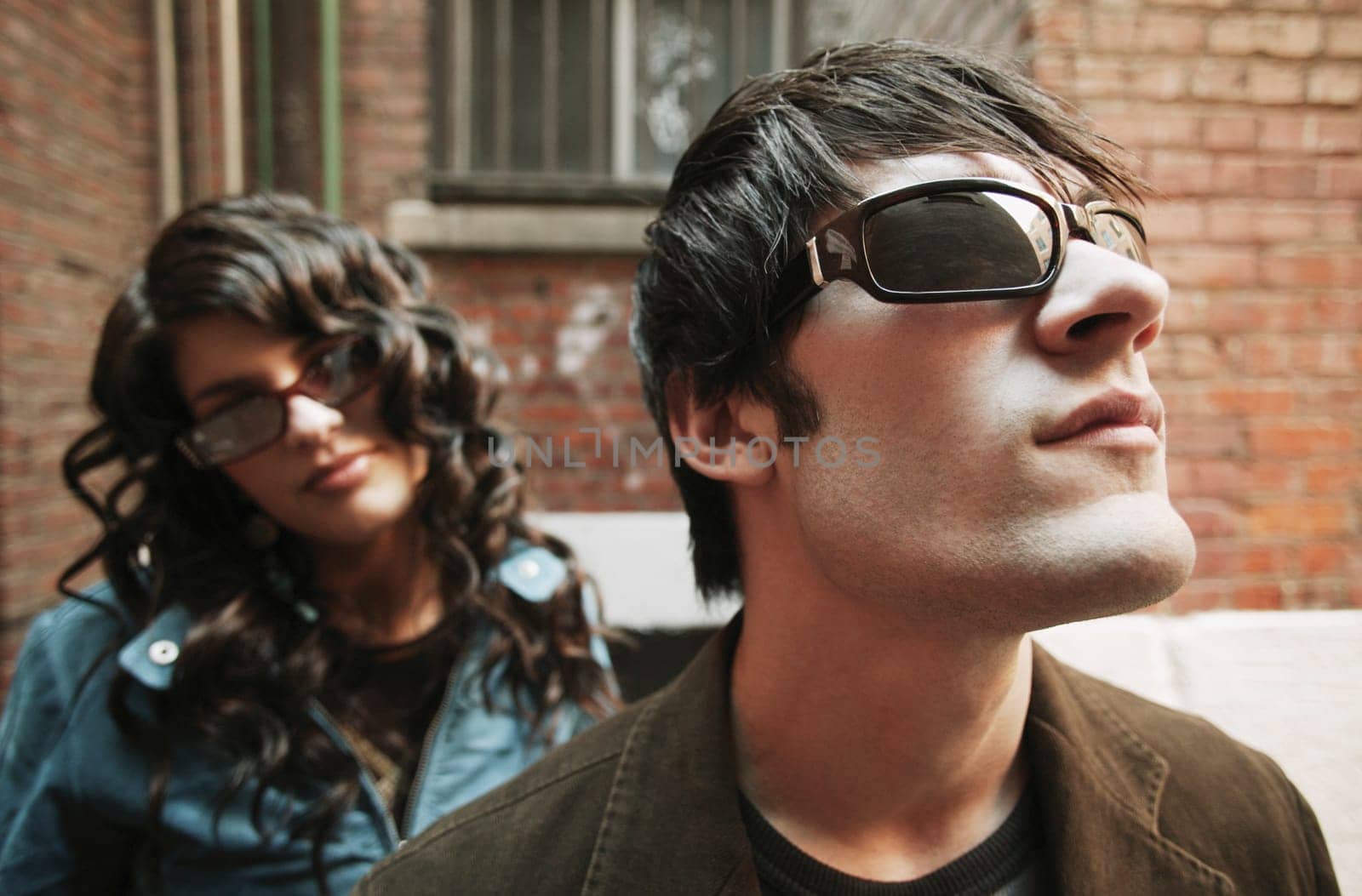 Trendy couple wearing sunglasses