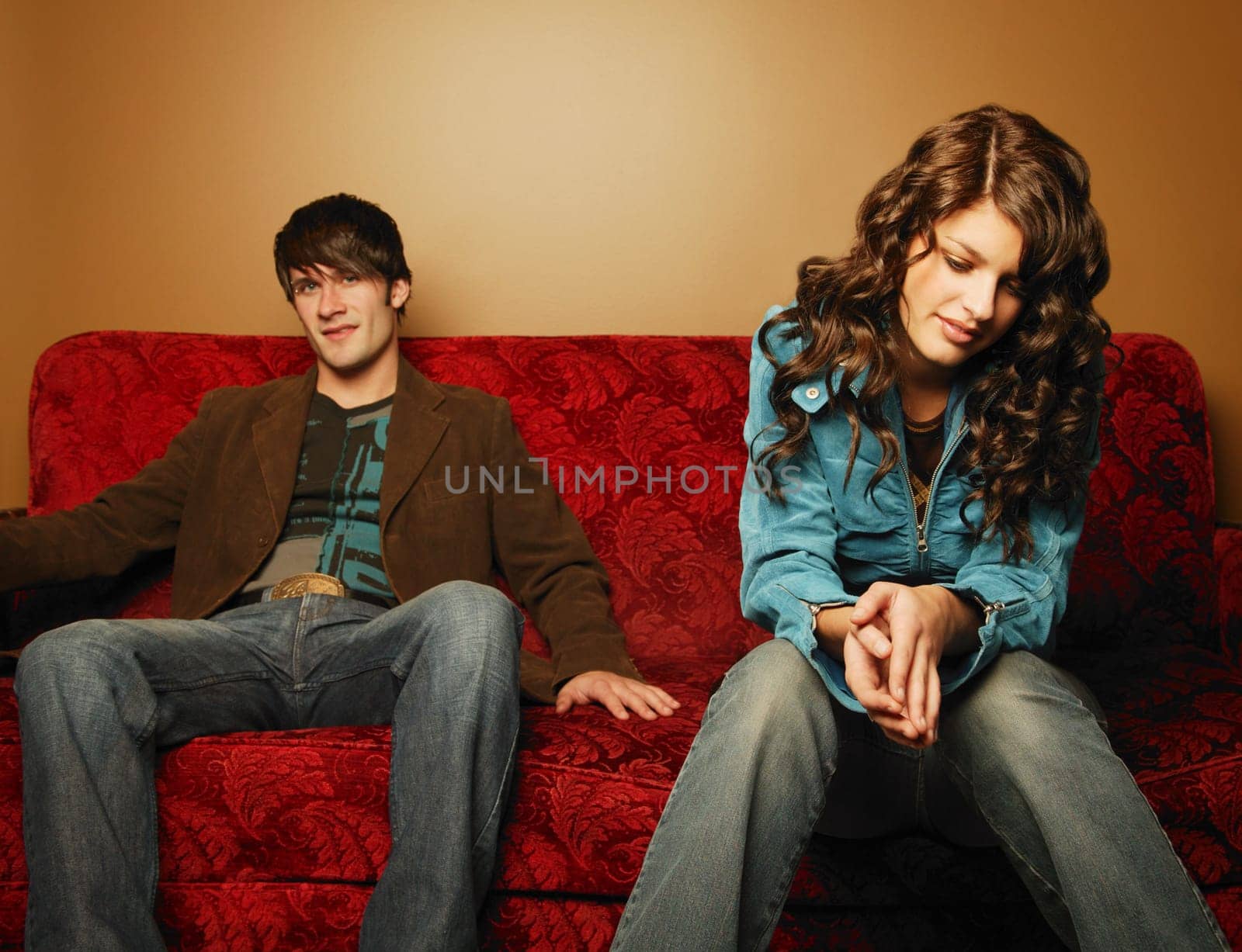 Trendy young couple sitting on sofa