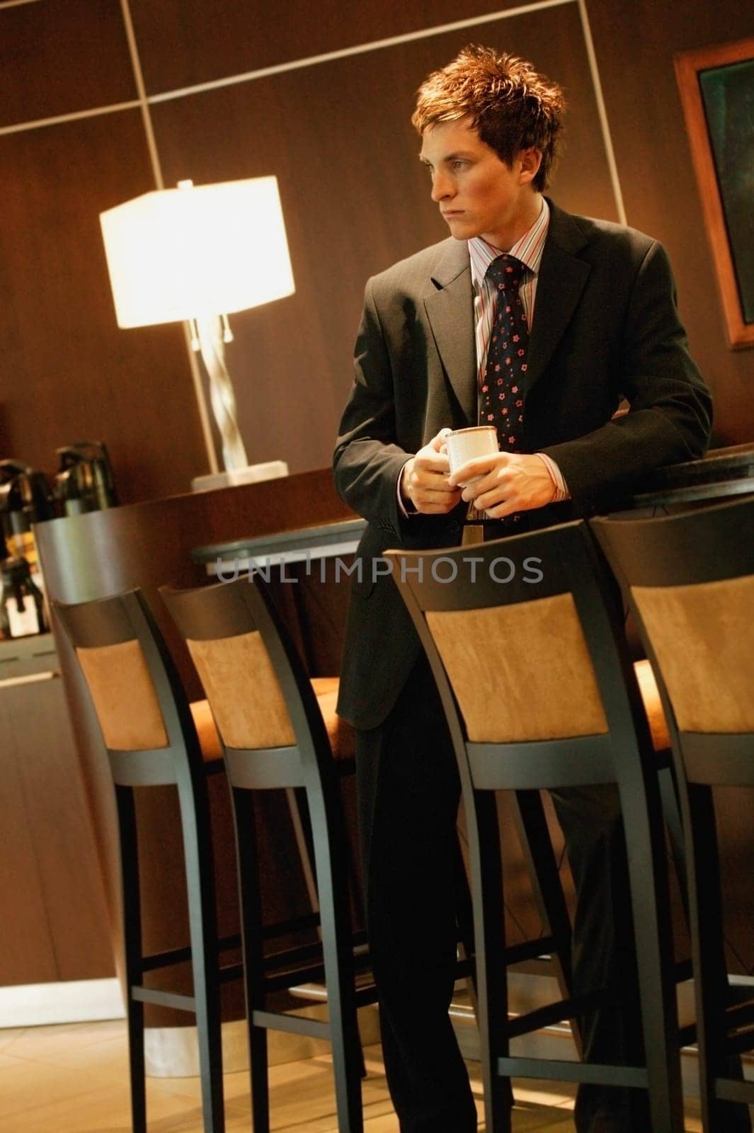 Businessman waiting with cup of coffee