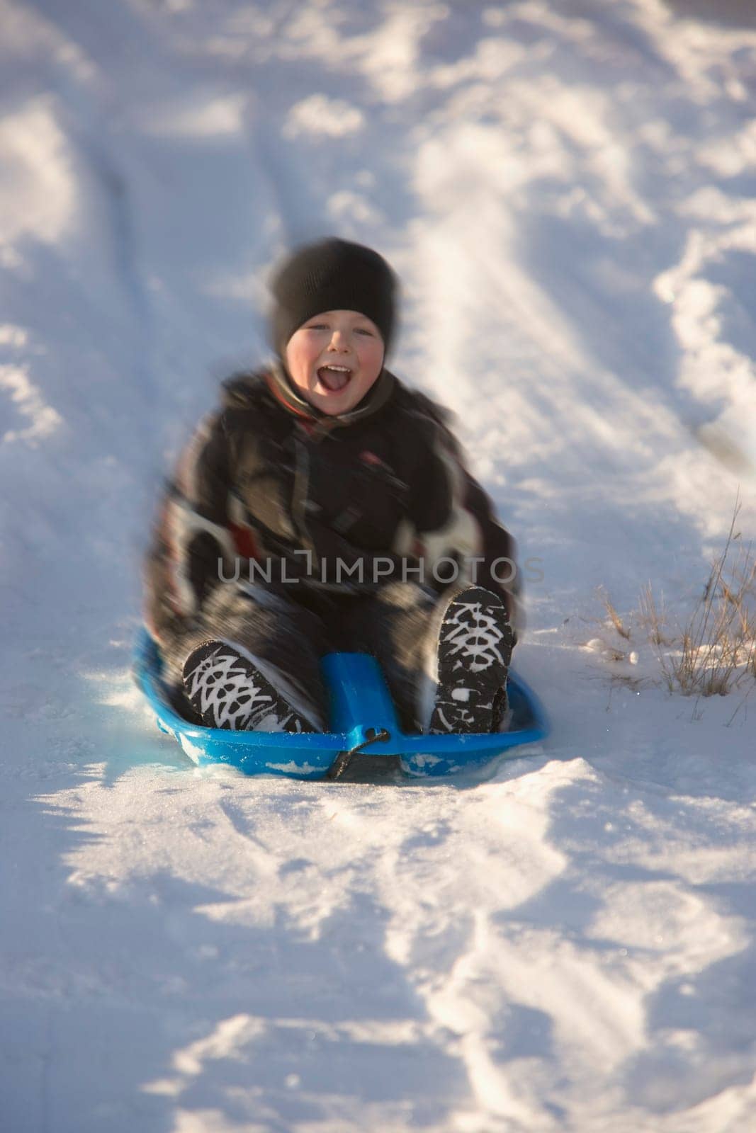 Boy tobogganing