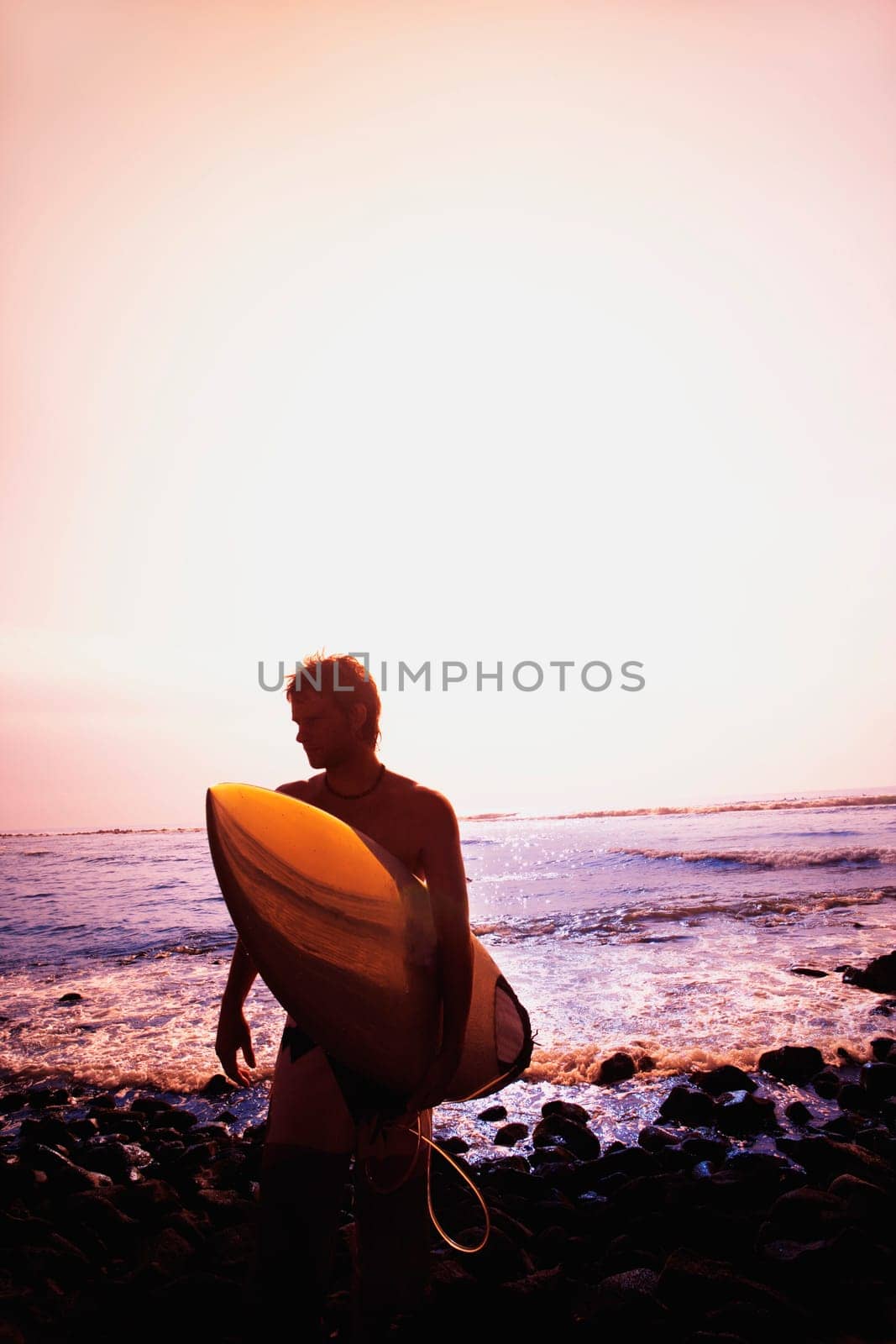 Surfer carrying surfboard