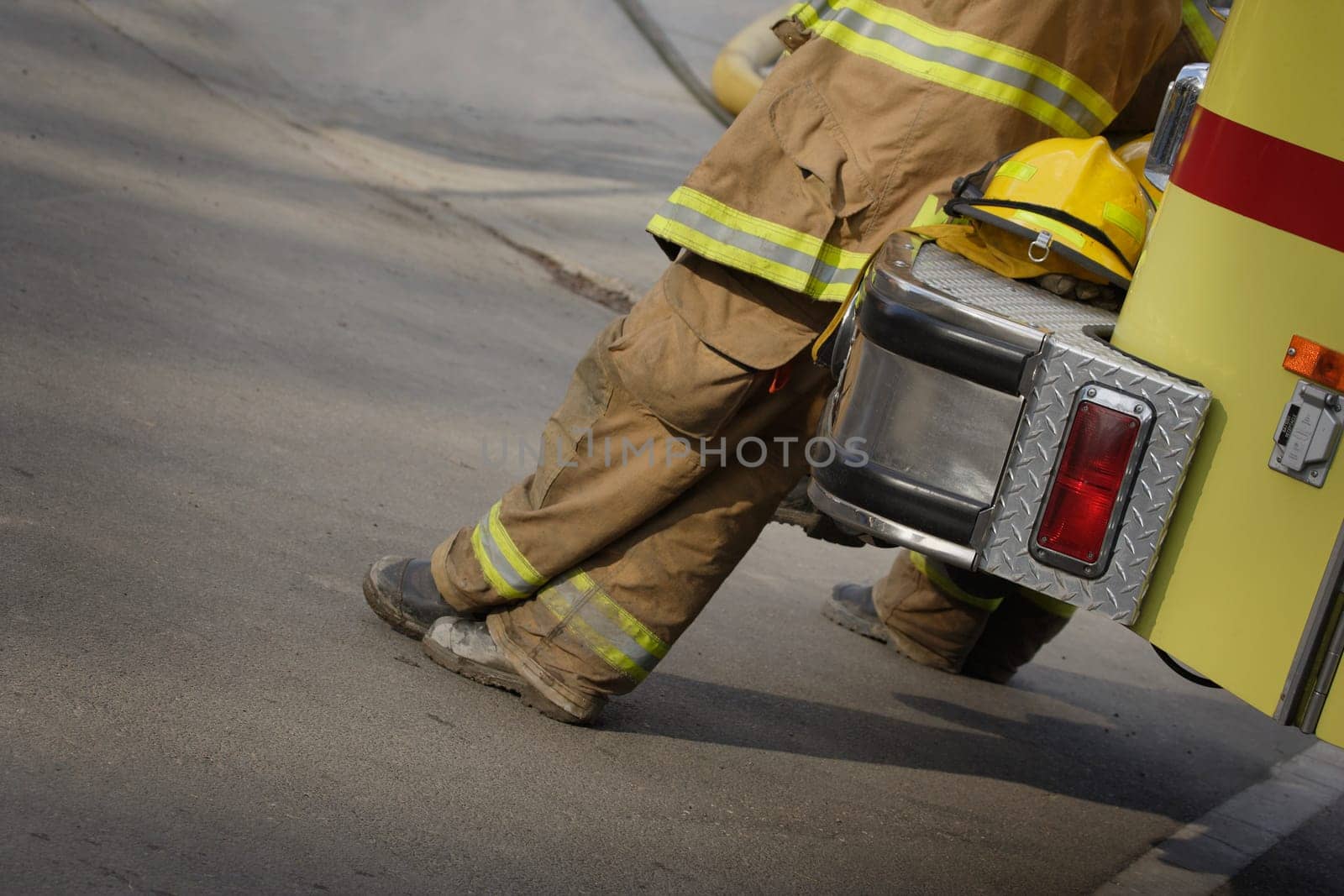 Firemen leaning against fire truck