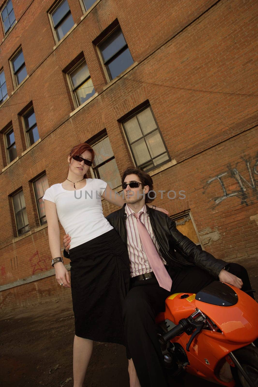 Fashionable couple and mini motorcycle