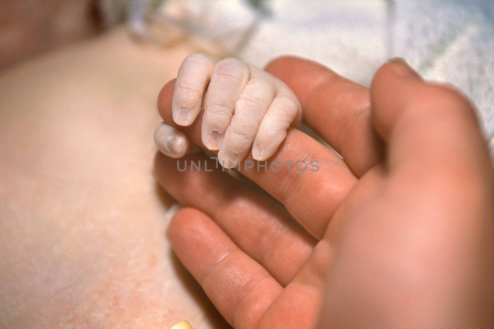 Newborn hand with mom
