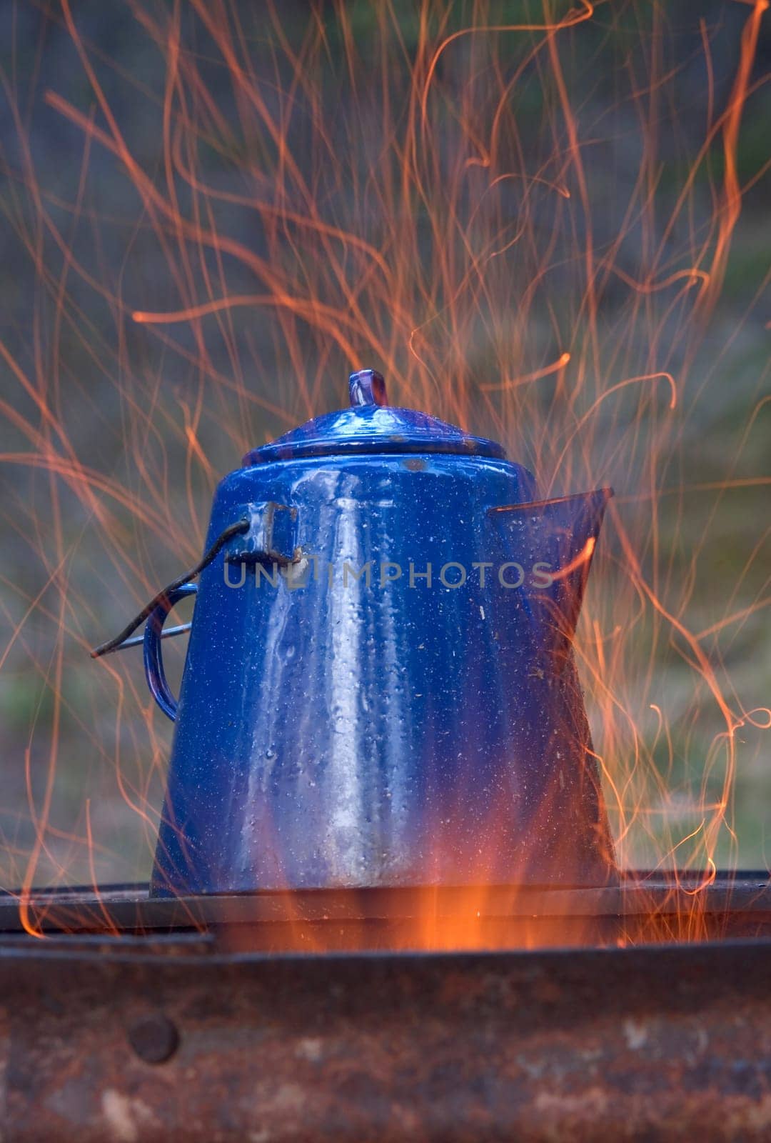 Kettle overtop of campfire