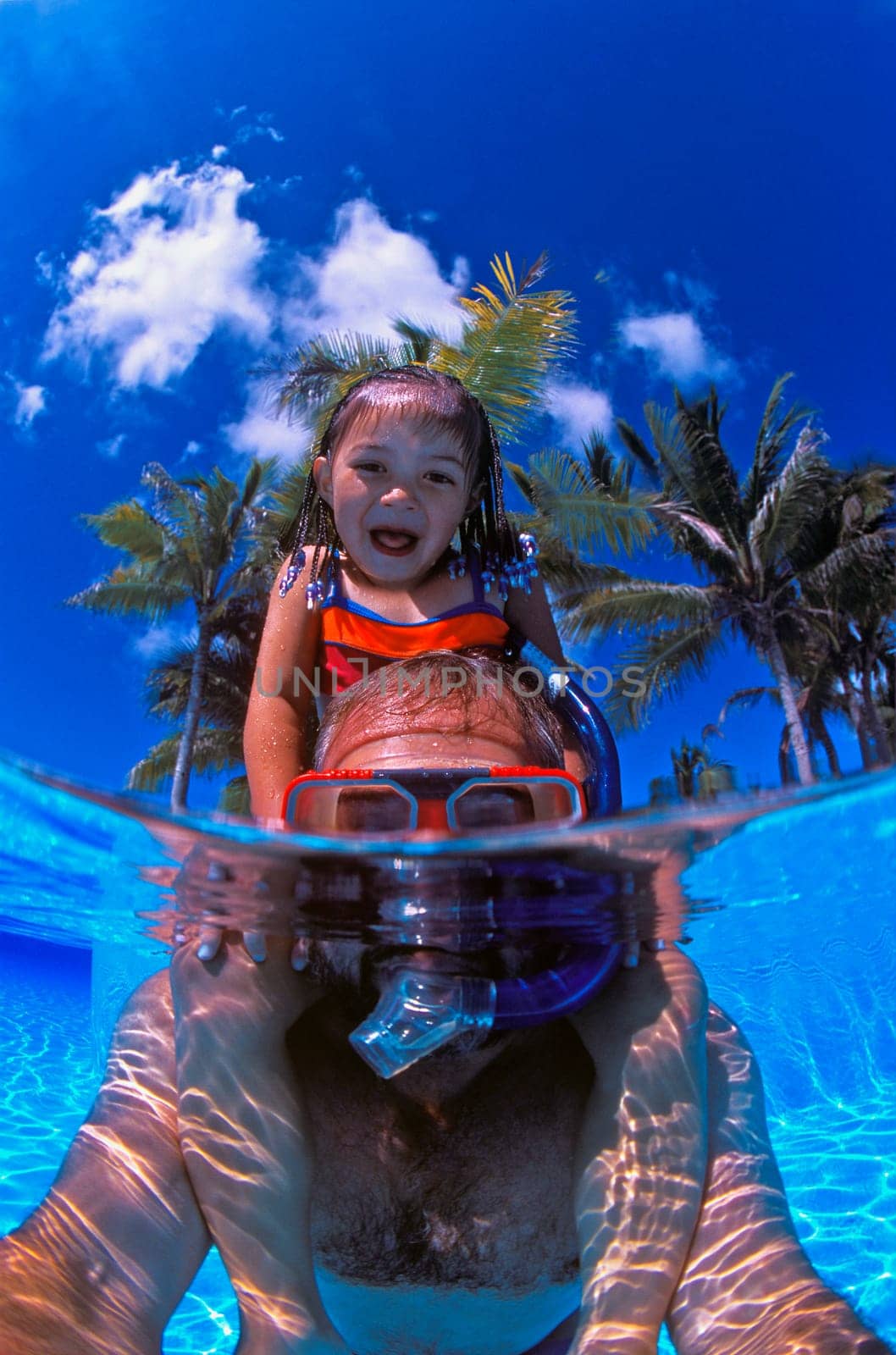 Father and daughter playing in the pool