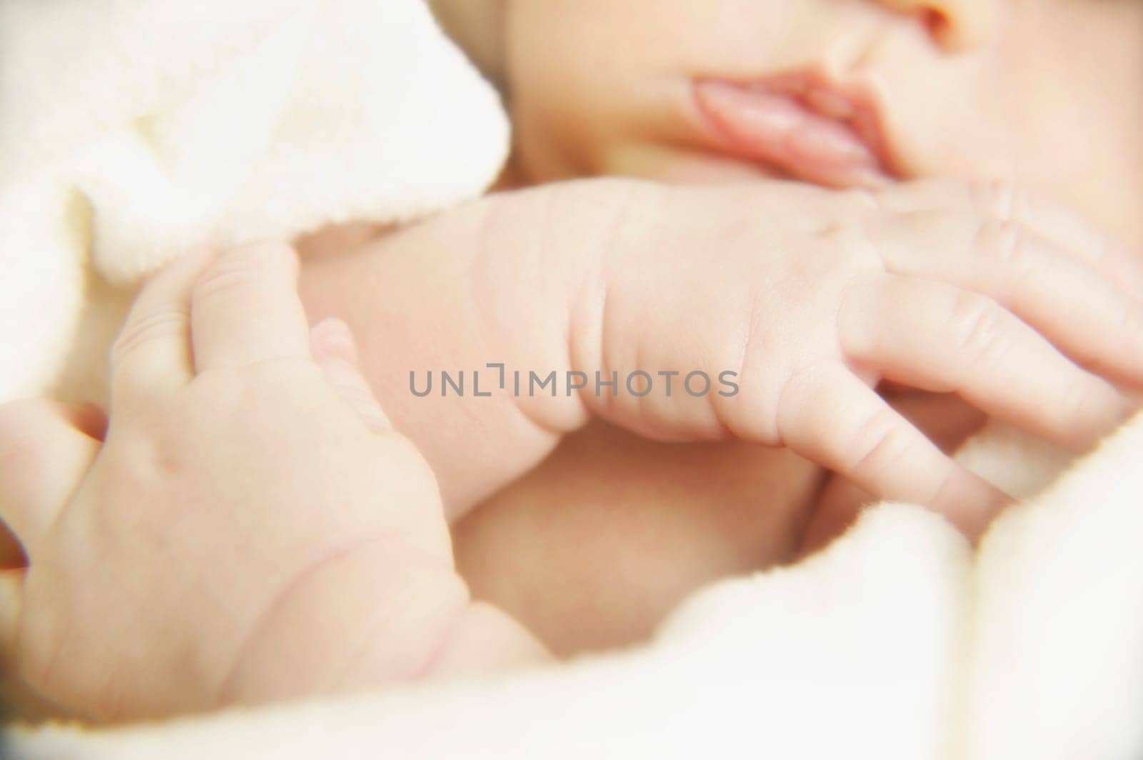 Portrait of a newborn's hands and mouth