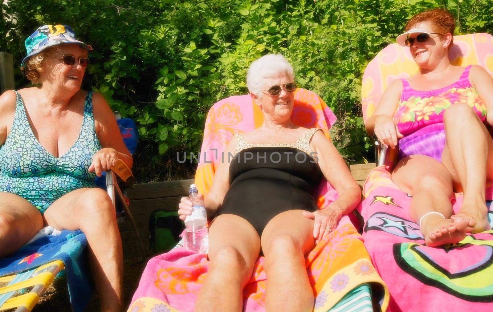 Group of three women sunbathing