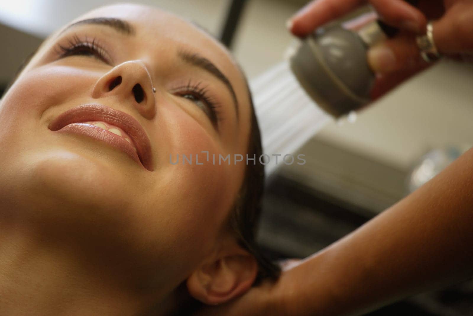 A woman getting her hair rinsed at a salon