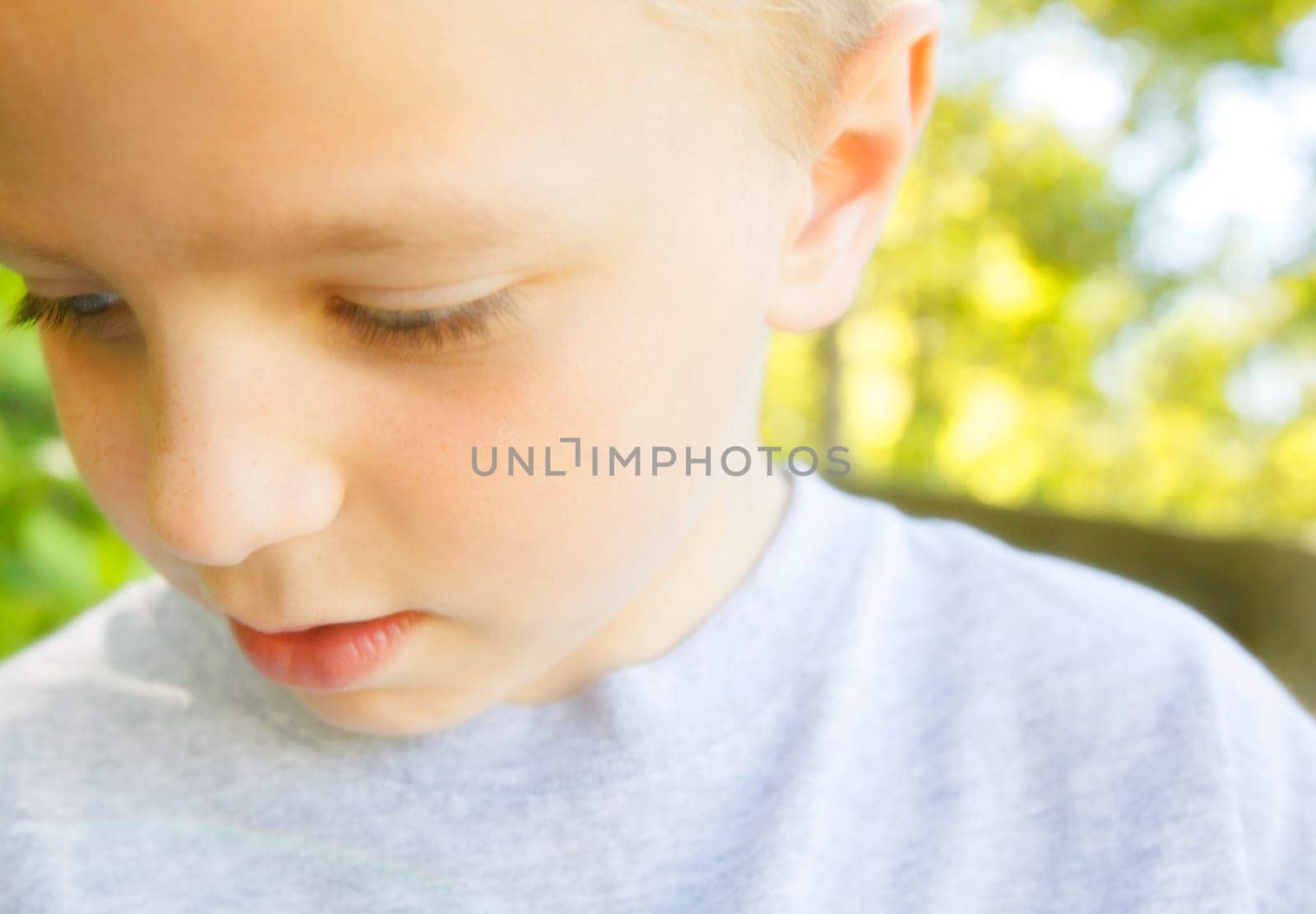 A young boy looking down