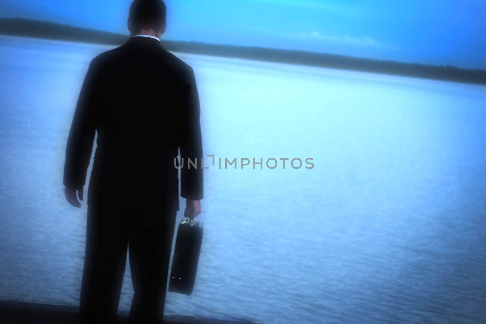 A man alone looking out over water