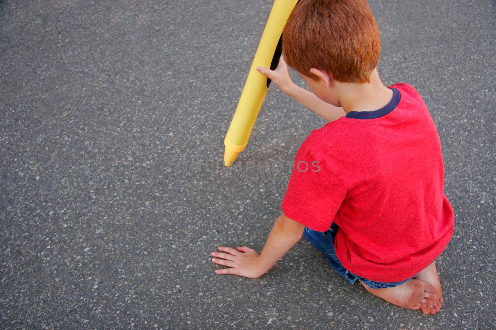 Small boy with large crayon