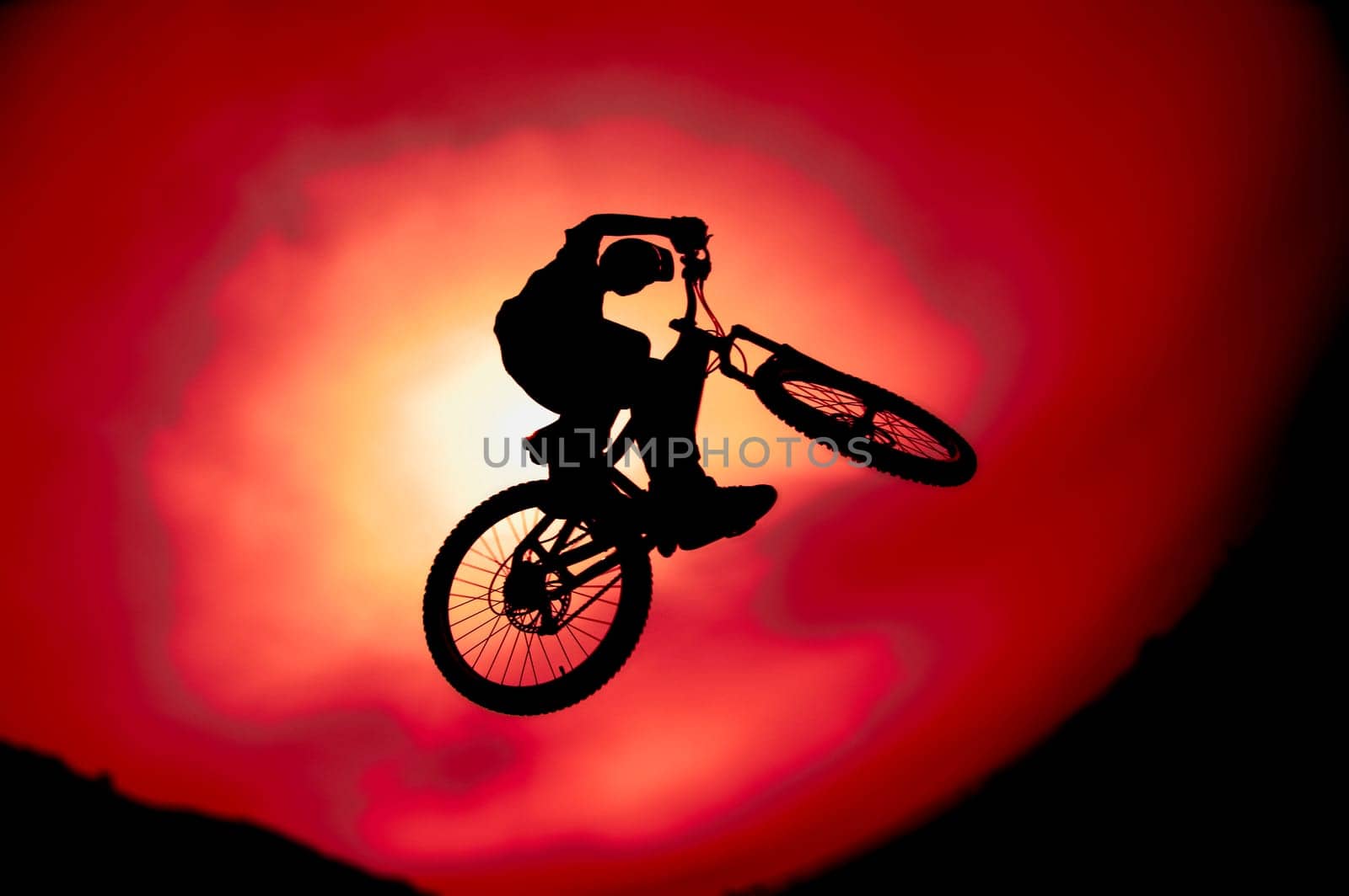 Silhouette of trick bike rider