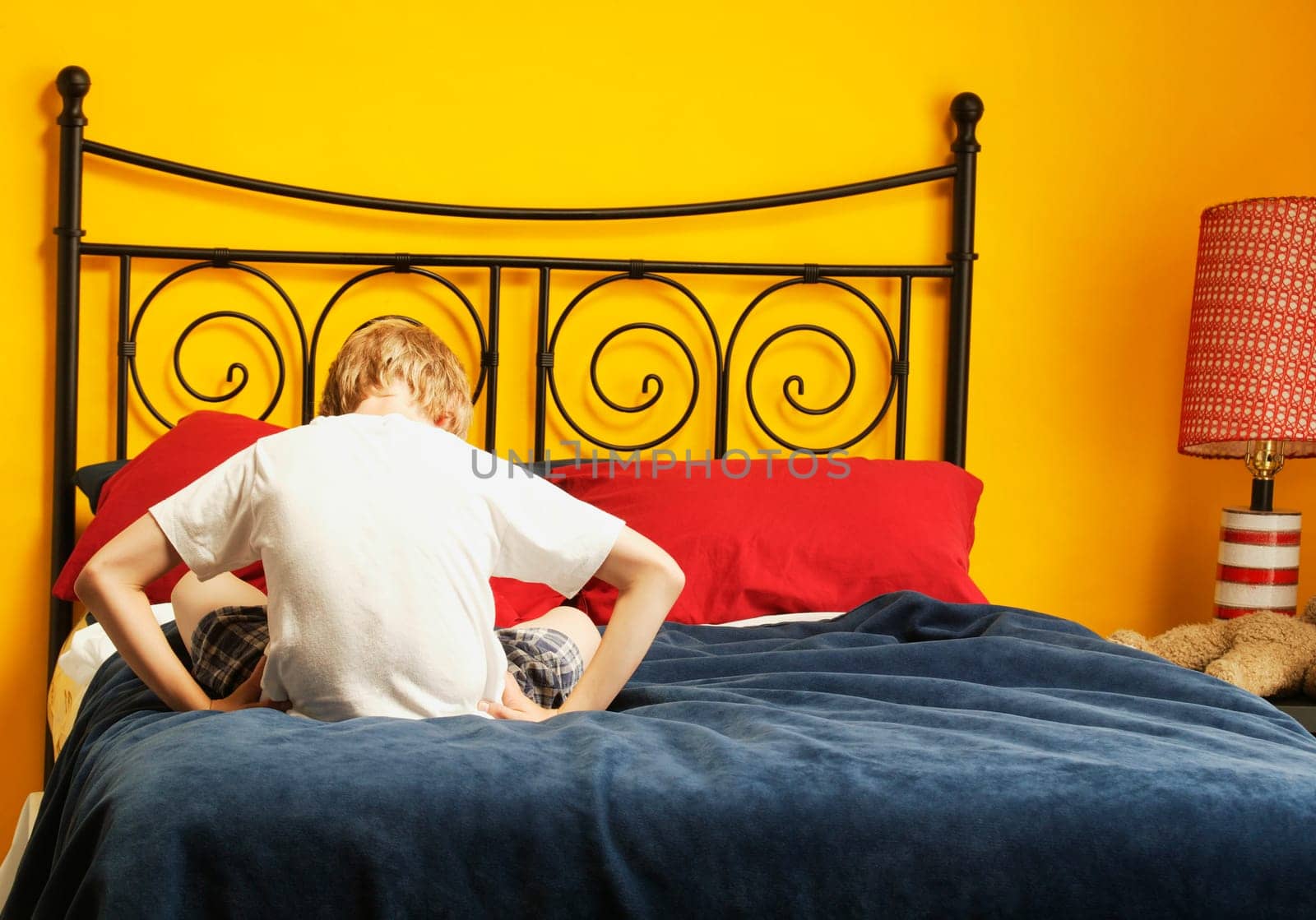 Child sulks on bed
