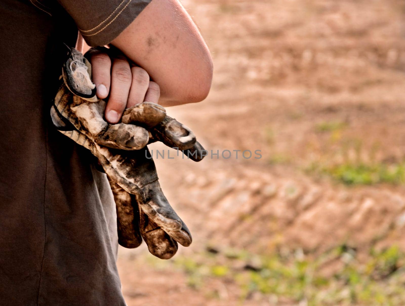 Man with worn gloves in hand