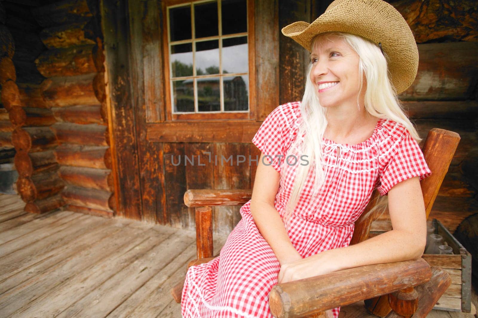 Cowgirl sits on patio