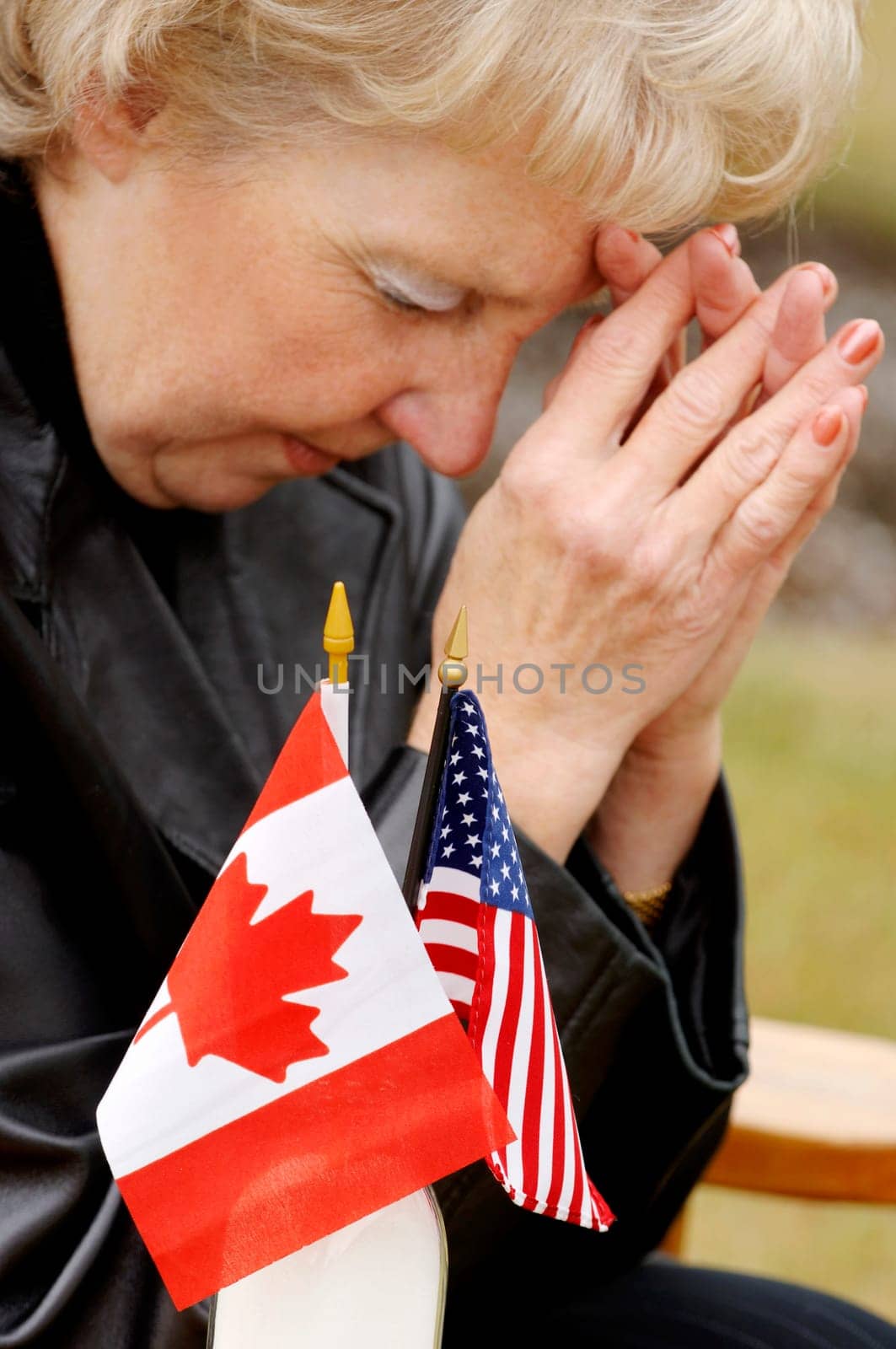Woman praying over flags from different countries