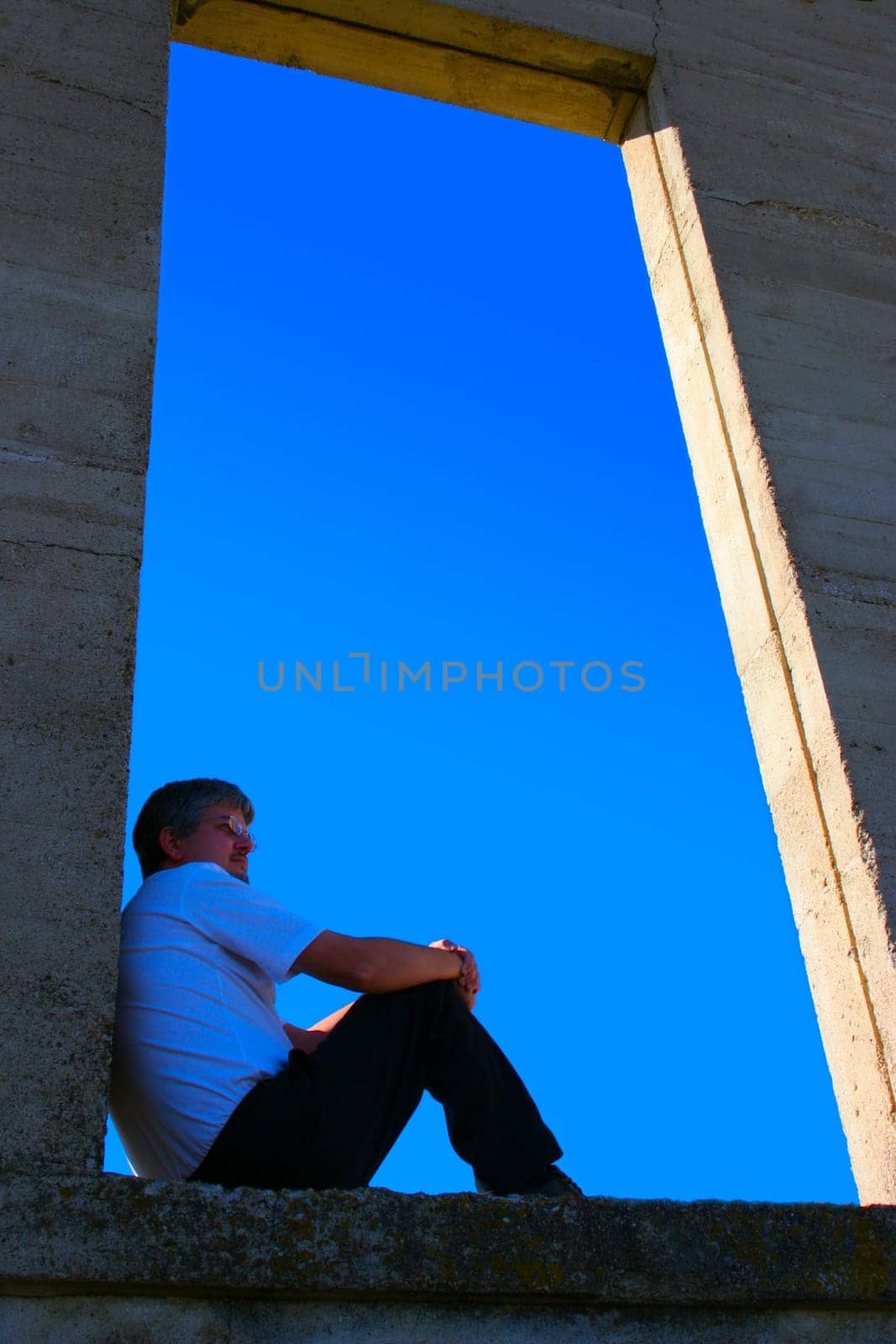 Man sitting on open ledge