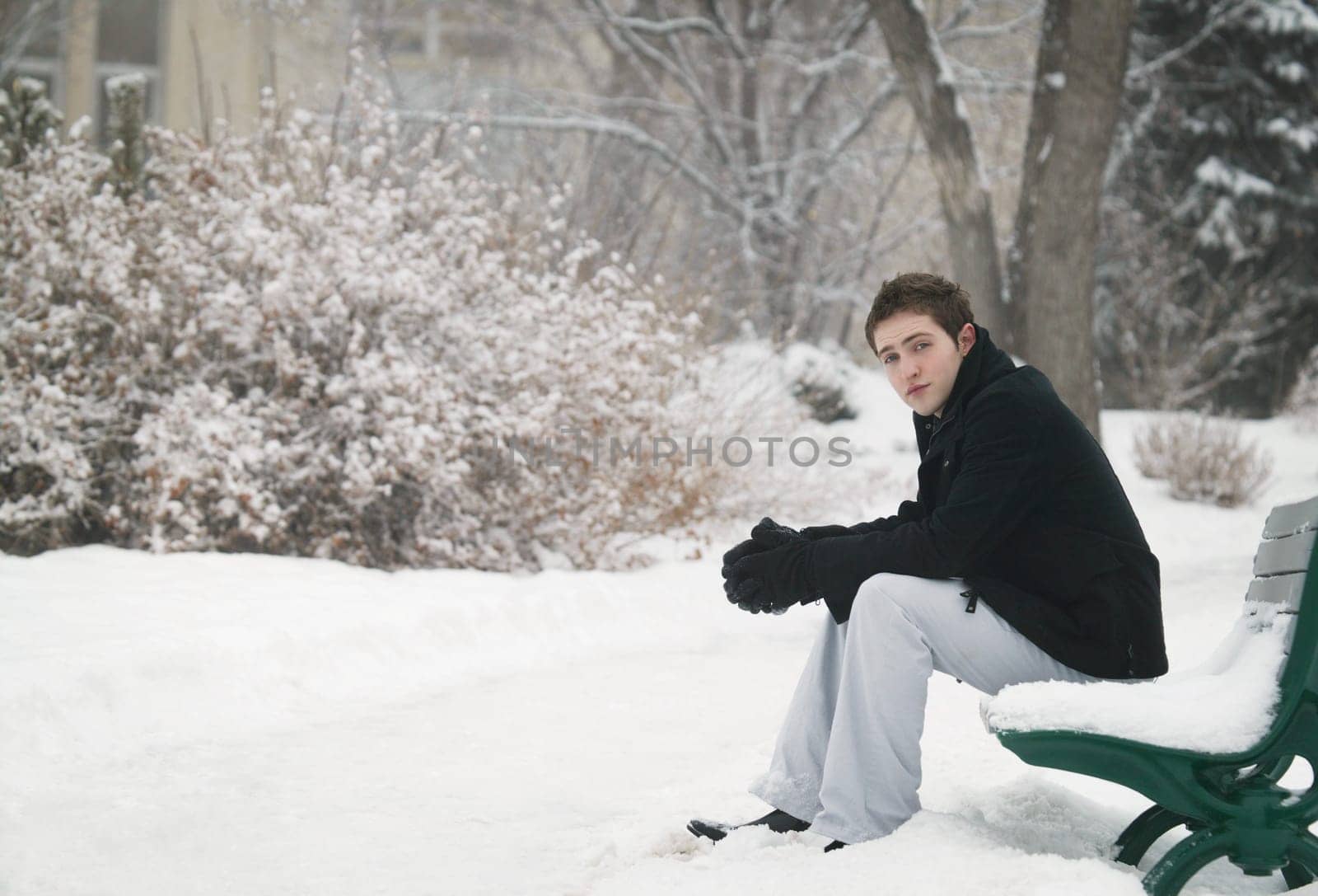Sitting on a snowy bench