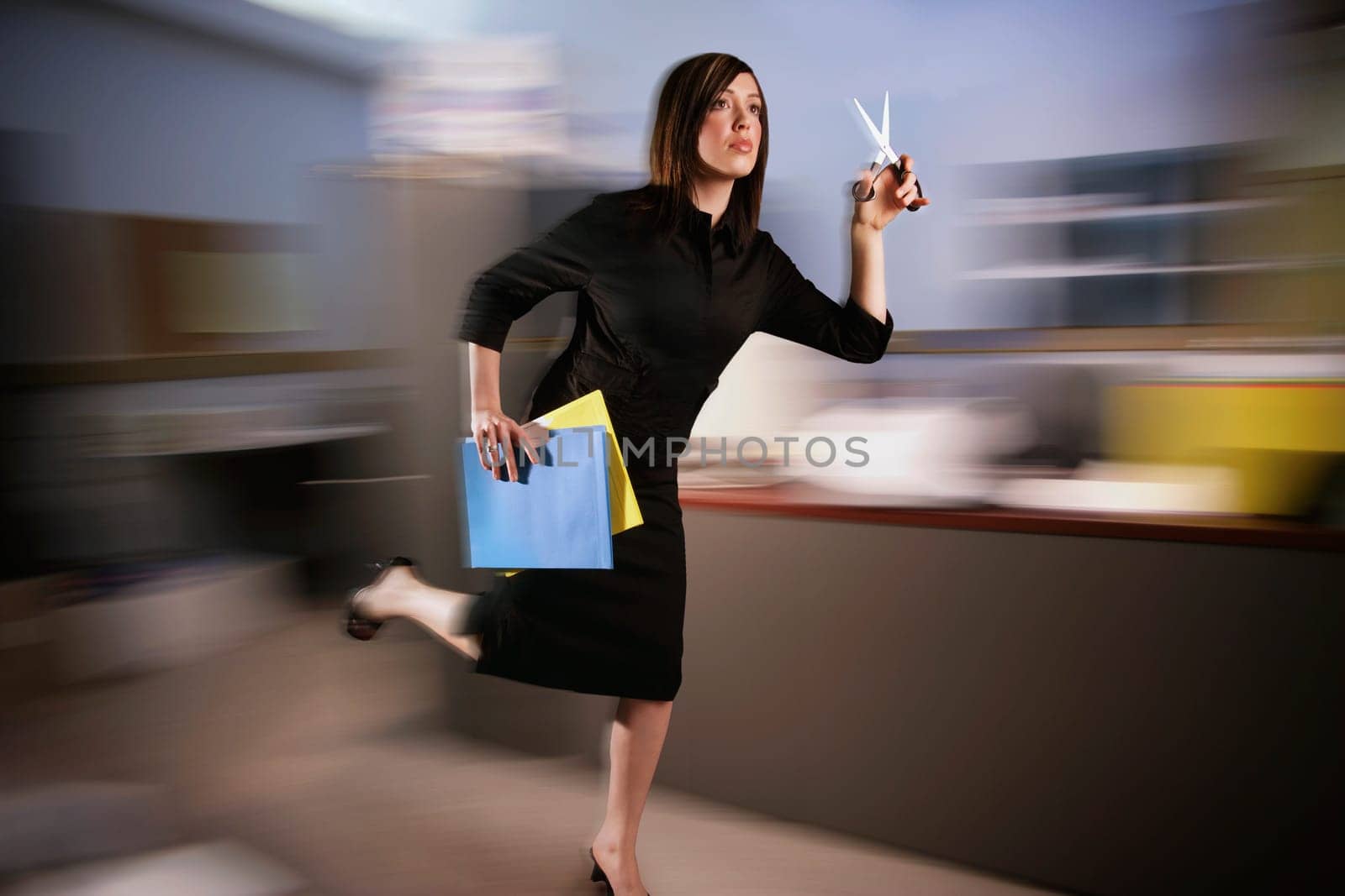 Woman runs with scissors through office
